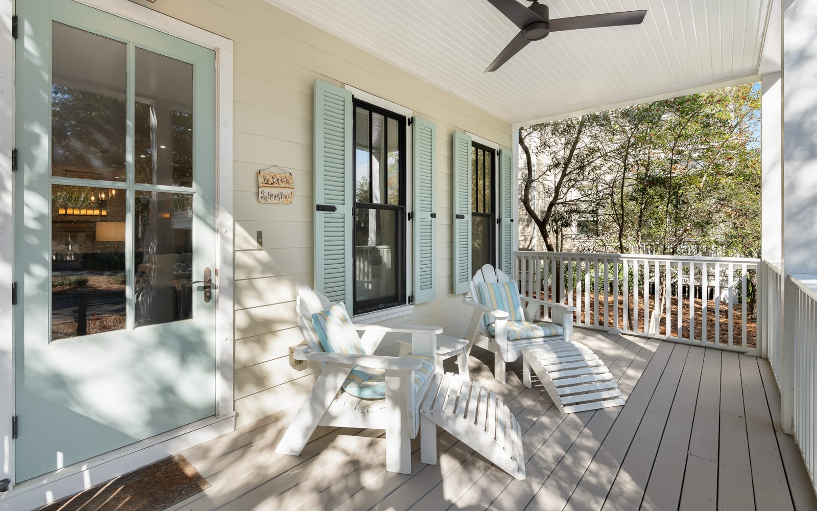 Settle into your peaceful covered porch with Adirondack chairs and watch the day unfold through leafy trees.