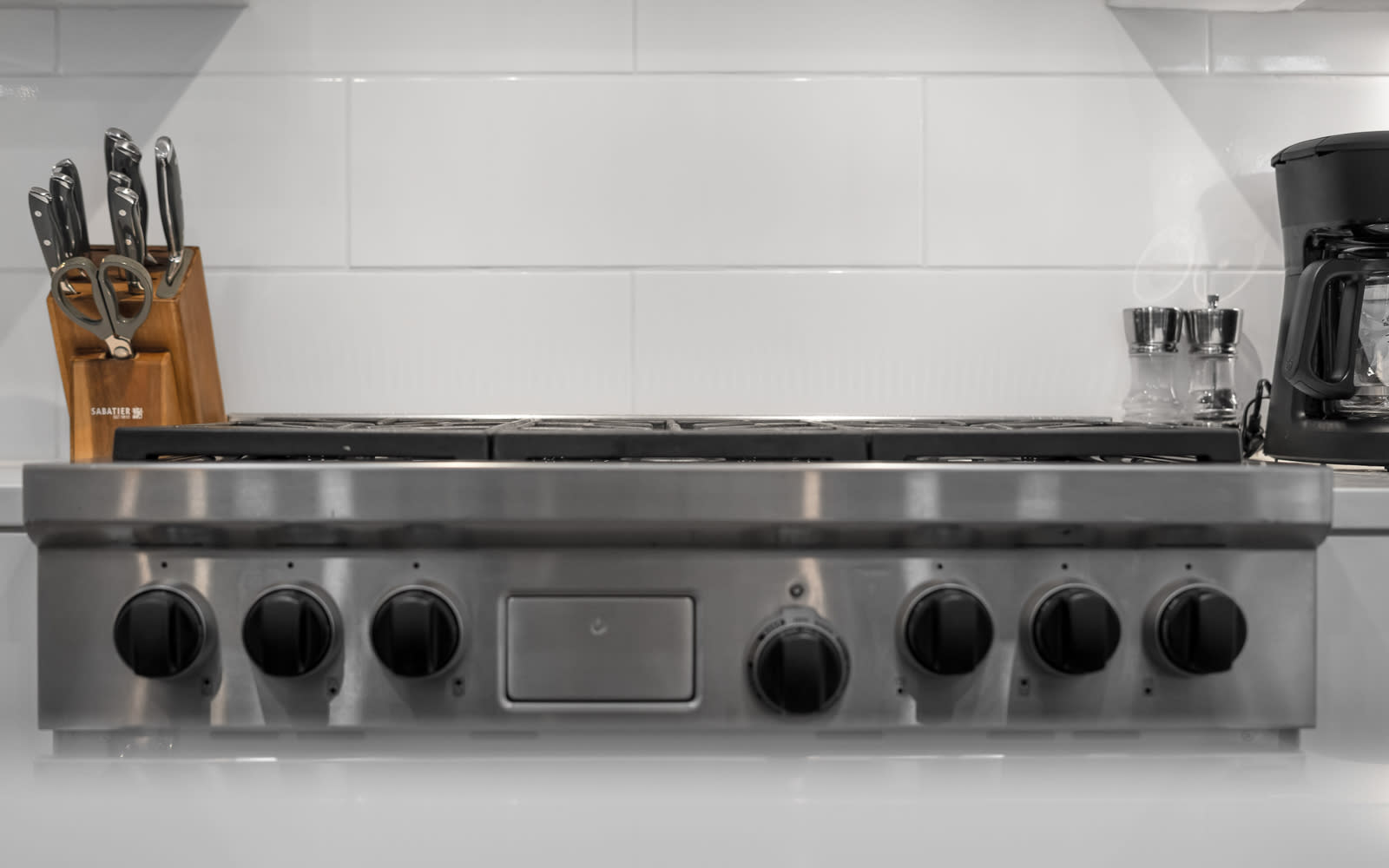 Your professional-grade stainless steel stove awaits culinary adventures, complete with quality knives and coffee maker for perfect mornings.