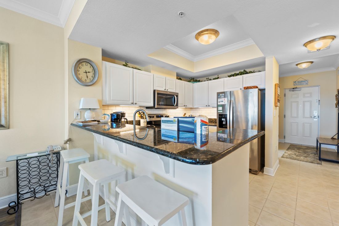 Cook together in this gorgeous kitchen with granite countertops, full-size appliances, and a breakfast bar for morning coffee.