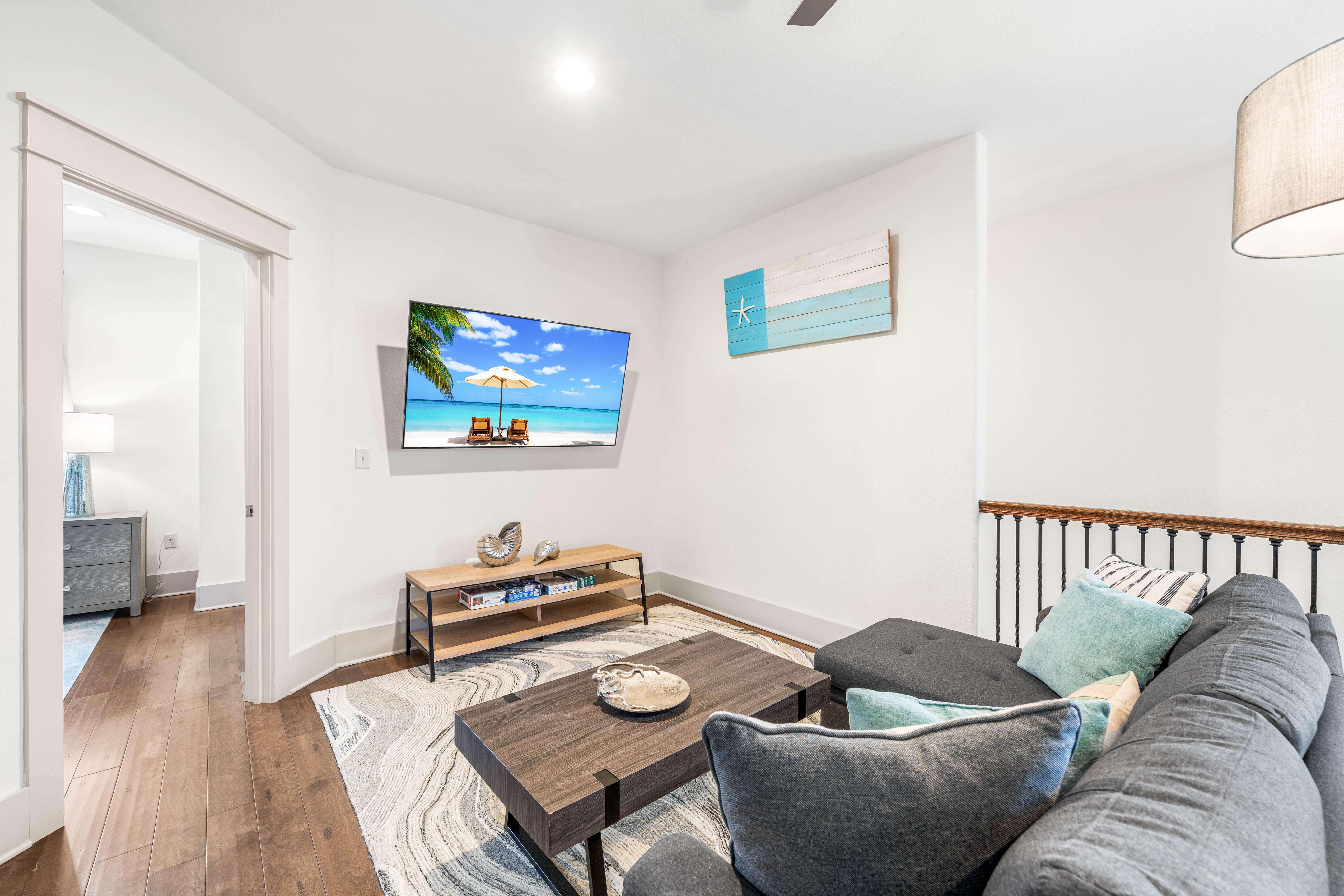 2nd floor bonus living area with kids in mind!  Table for 6 perfect for games or puzzles.  Sofa & 65" Smart TV with Cable Also!!