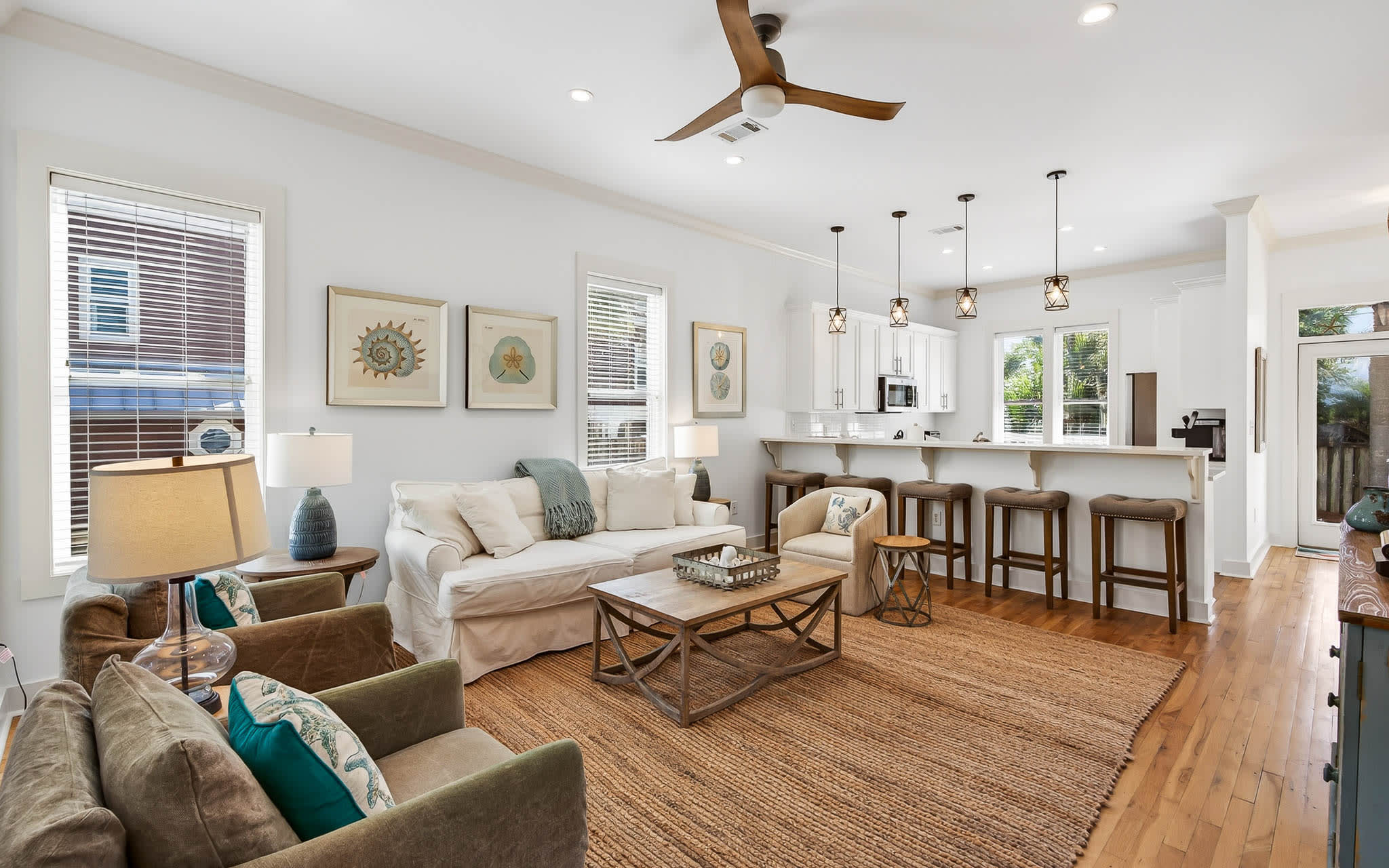 Relax in your spacious open-concept living space with coastal decor, comfortable seating, and a chef's kitchen perfect for vacation meals.