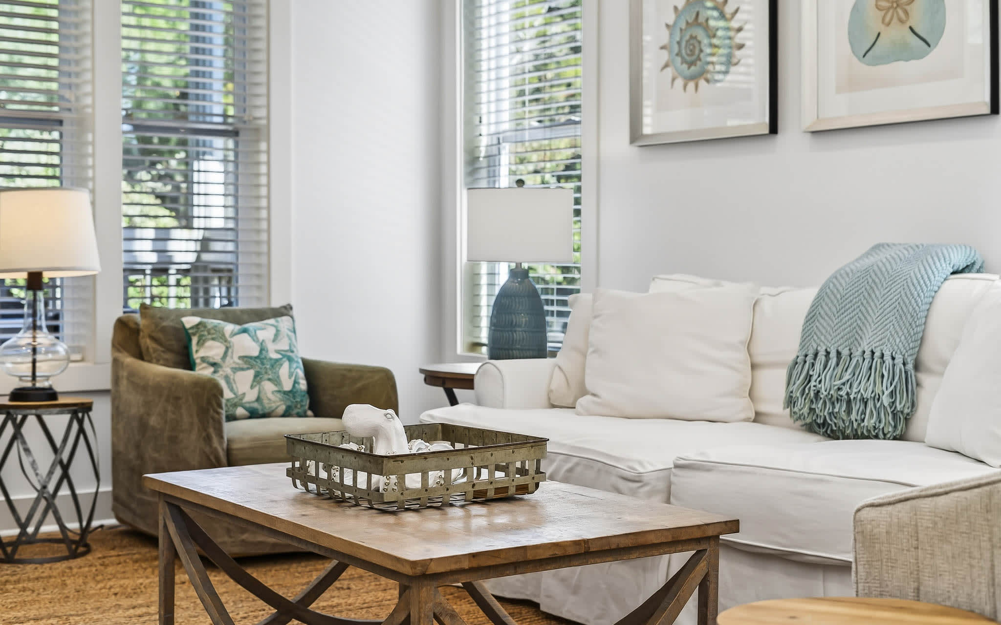 Sink into plush sofas in your bright, airy living room where coastal touches and natural light create the perfect retreat.