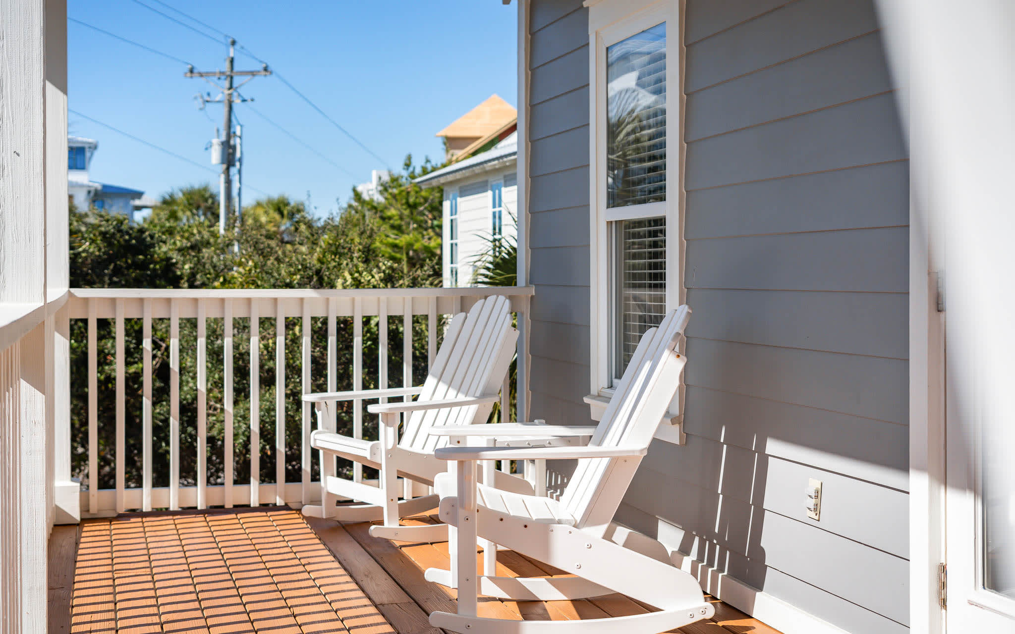 Soak up the sunshine on your private balcony with classic Adirondack chairs—perfect for morning coffee or sunset relaxation.