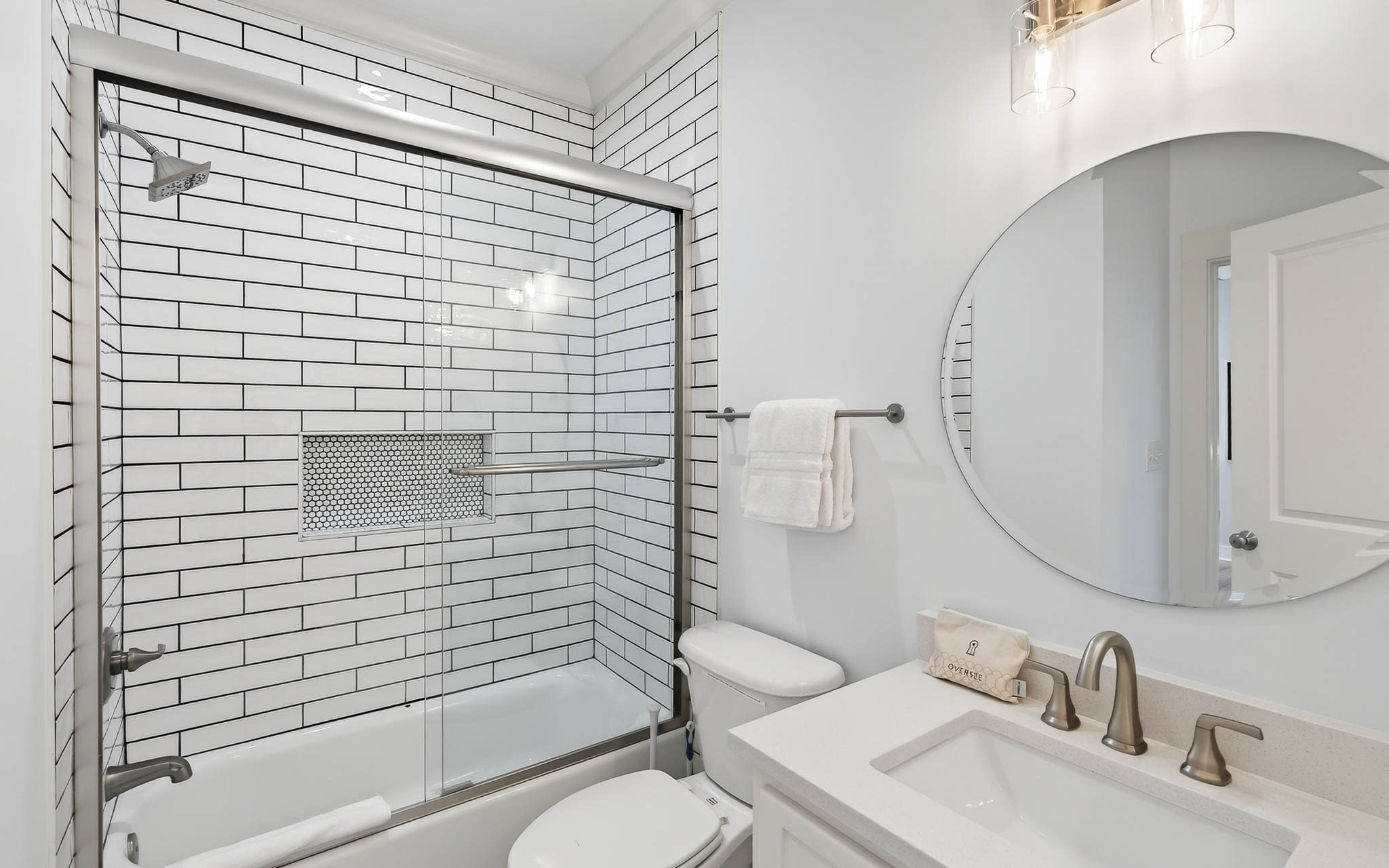 Refresh yourself in this bright, modern bathroom featuring elegant subway tile, spacious tub-shower combo, and premium fixtures for your comfort.