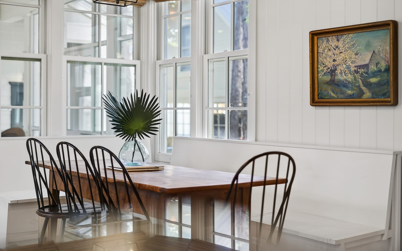 Gather around this beautiful dining table where natural light streams through windows, creating the perfect spot for your morning coffee or evening meals together.