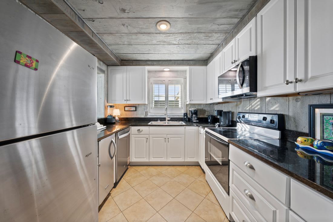 Your fully equipped kitchen features modern stainless steel appliances and granite counters, perfect for preparing family meals together.