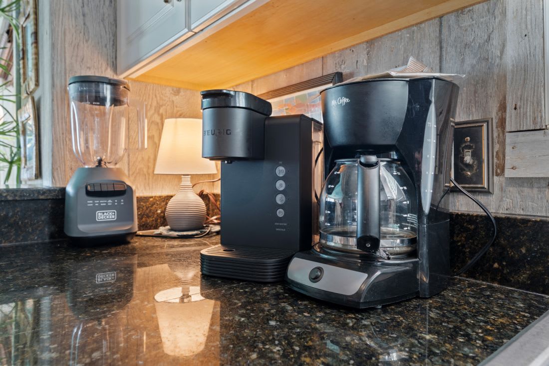 Wake up to fresh coffee from your well-equipped kitchen featuring a premium coffee maker, grinder, and blender for delicious mornings.