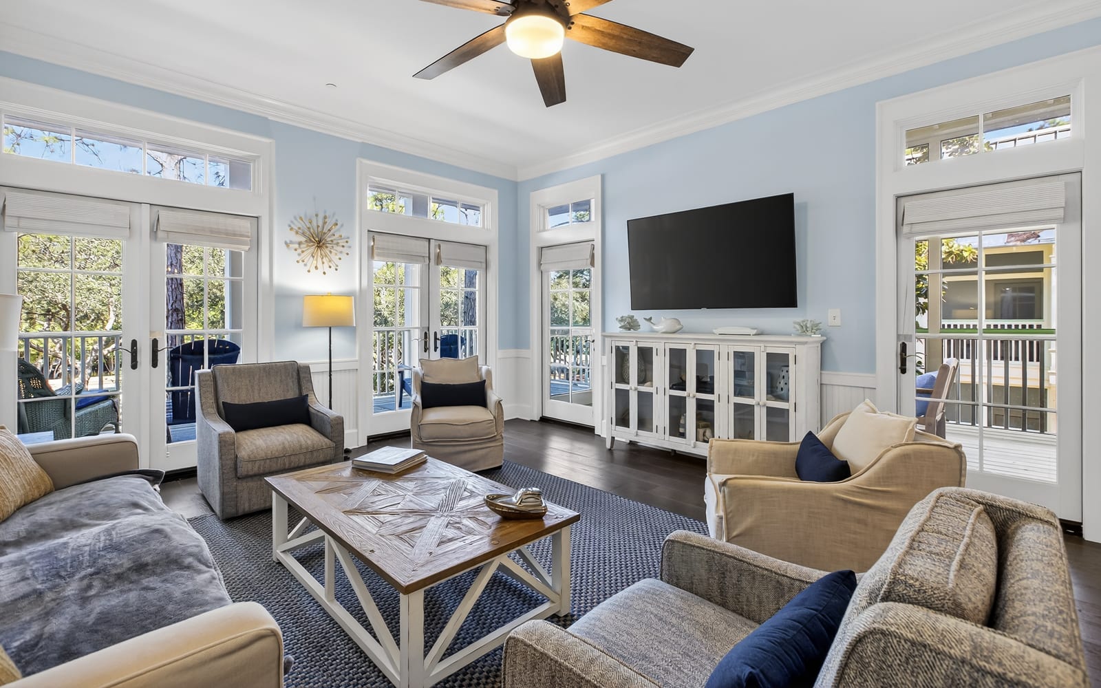 Unwind in your bright, airy living room with French doors opening to private balconies and comfortable seating for memorable moments.