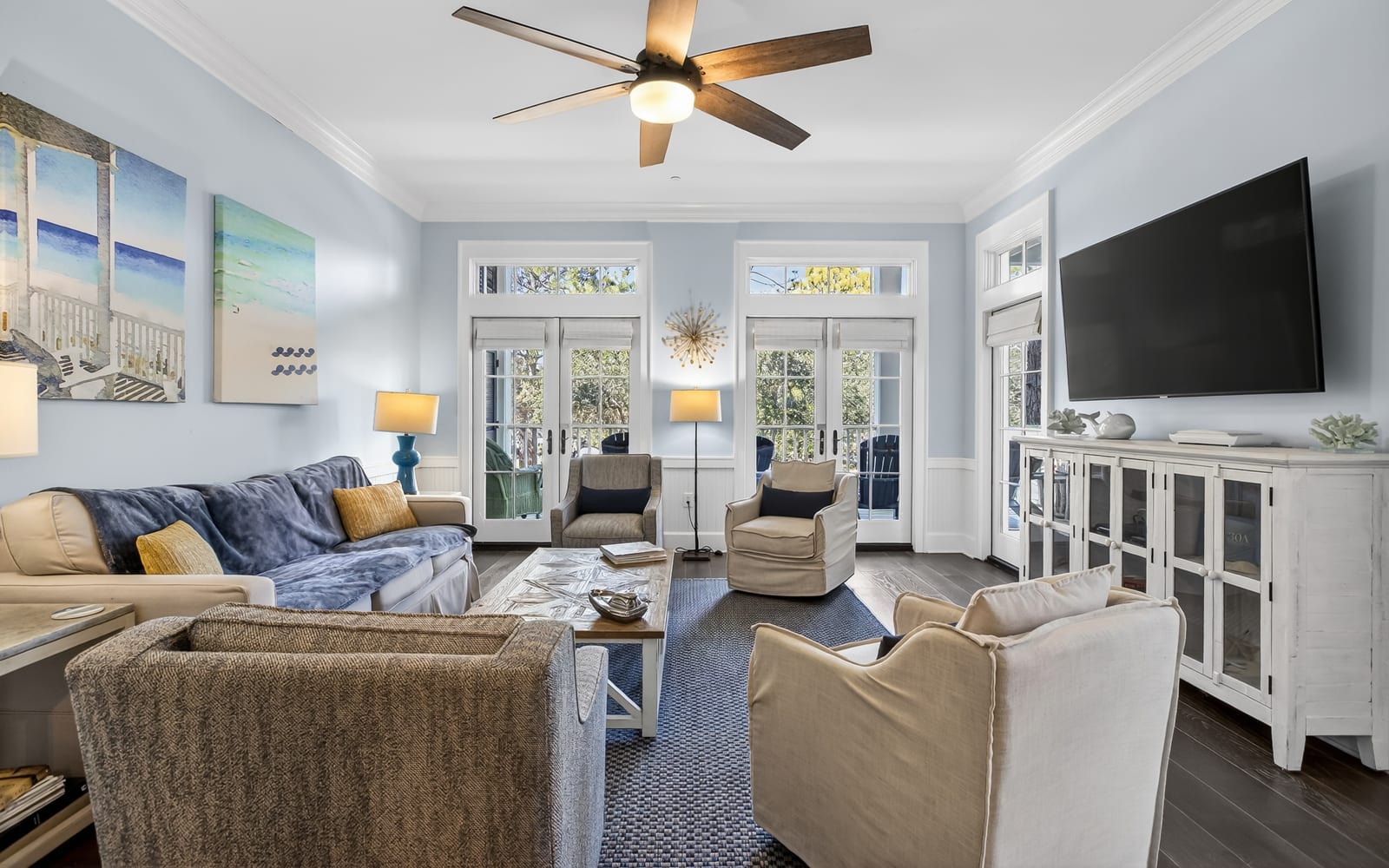 Settle into this bright, airy living room where coastal charm meets comfort. Plush seating and calming blues create your perfect relaxation retreat.