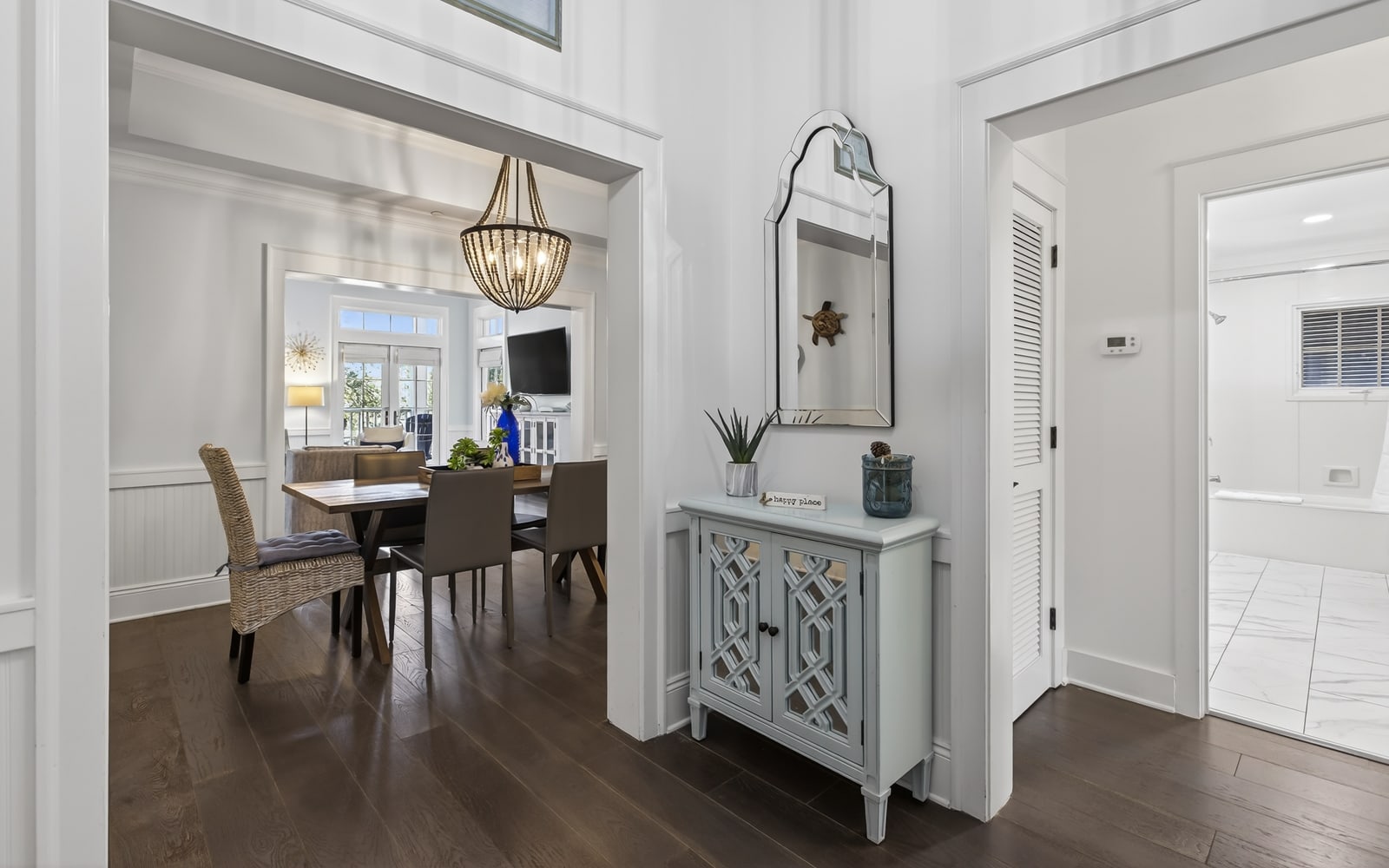Elegant foyer welcomes you with coastal charm and refined touches, leading to beautifully appointed dining and living spaces.
