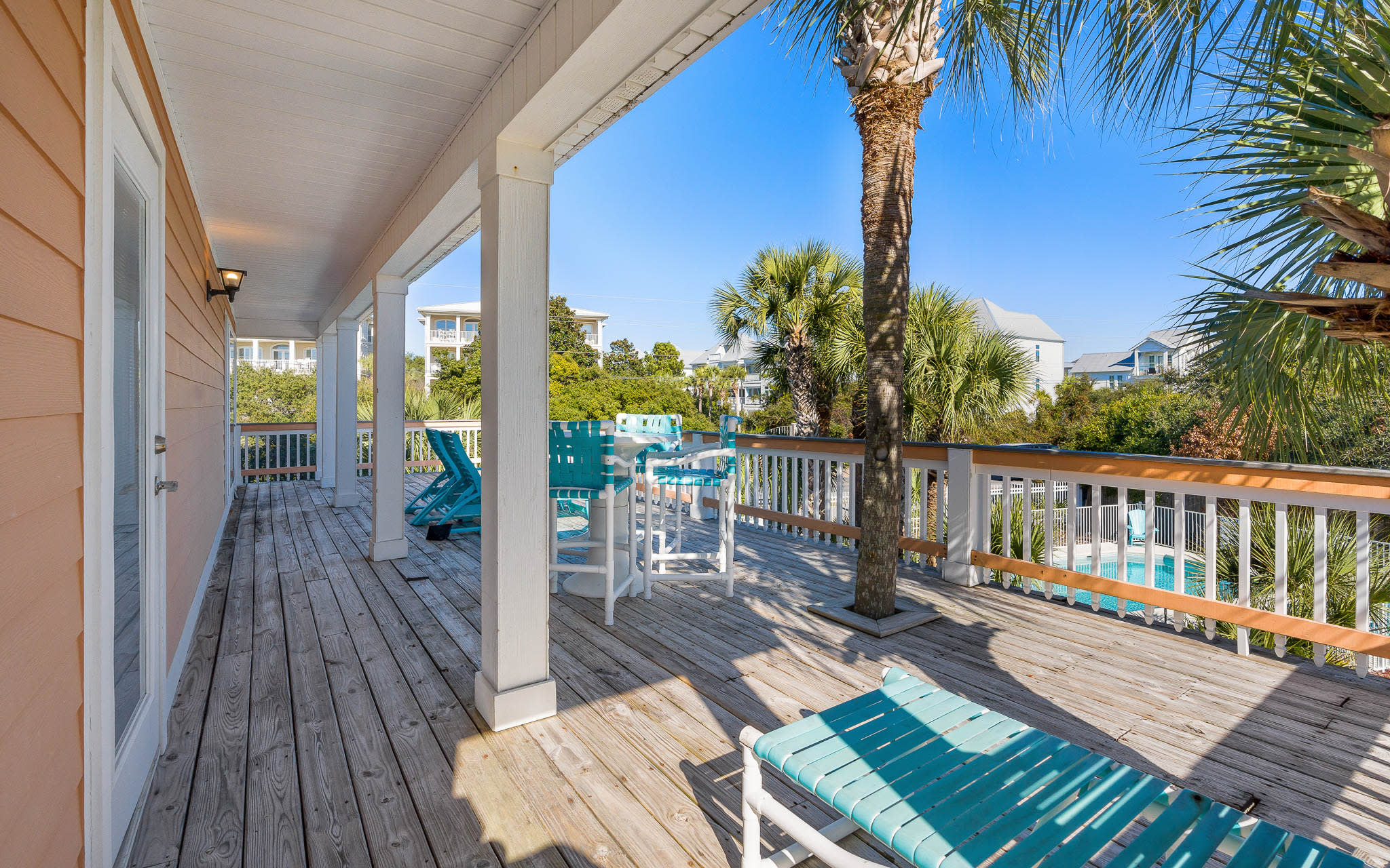 Your private deck offers turquoise pool views and tropical palm shade—perfect for morning coffee or sunset cocktails.