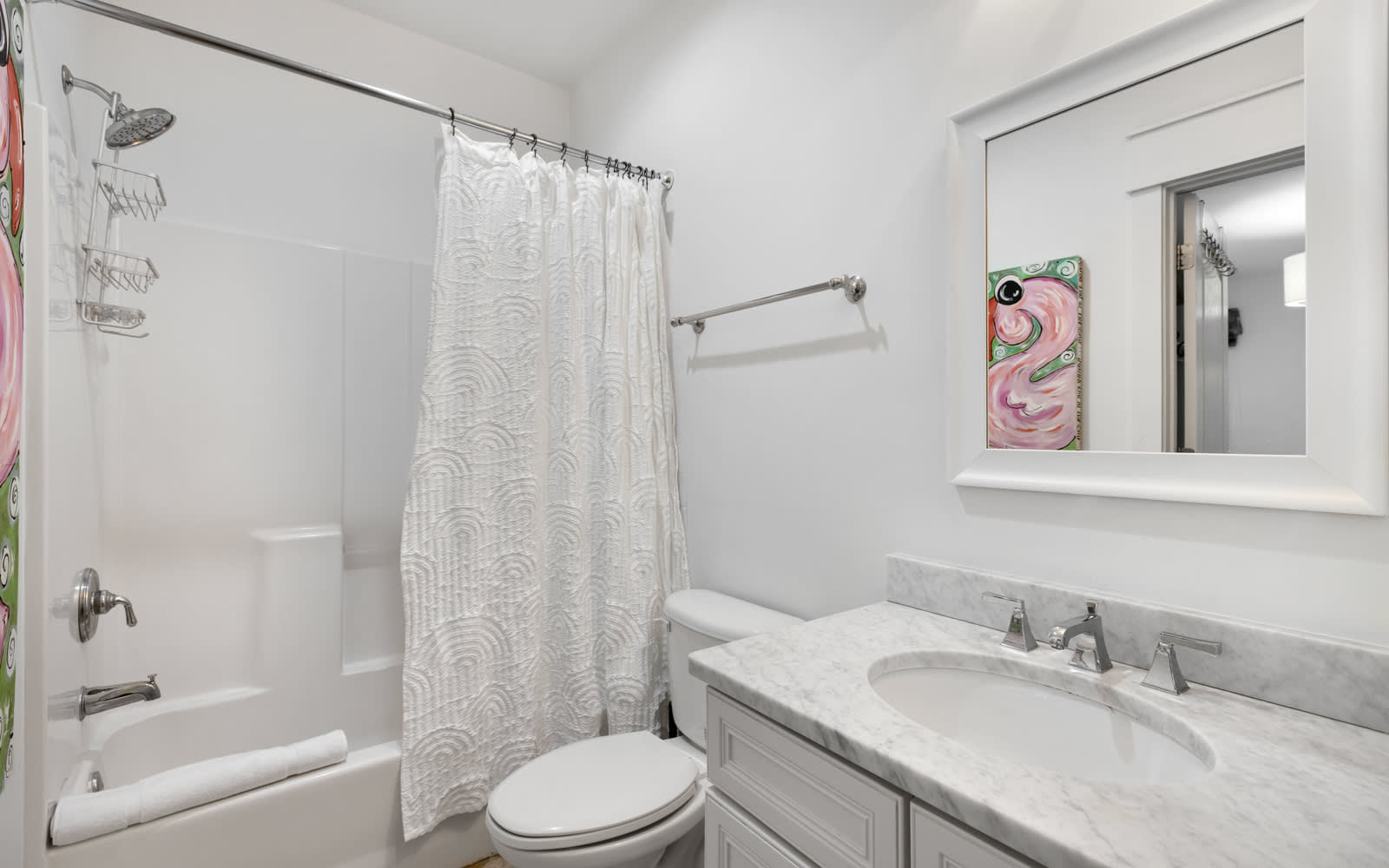 Step into your pristine private bathroom with elegant marble counters, fresh towels, and a relaxing tub-shower combo.