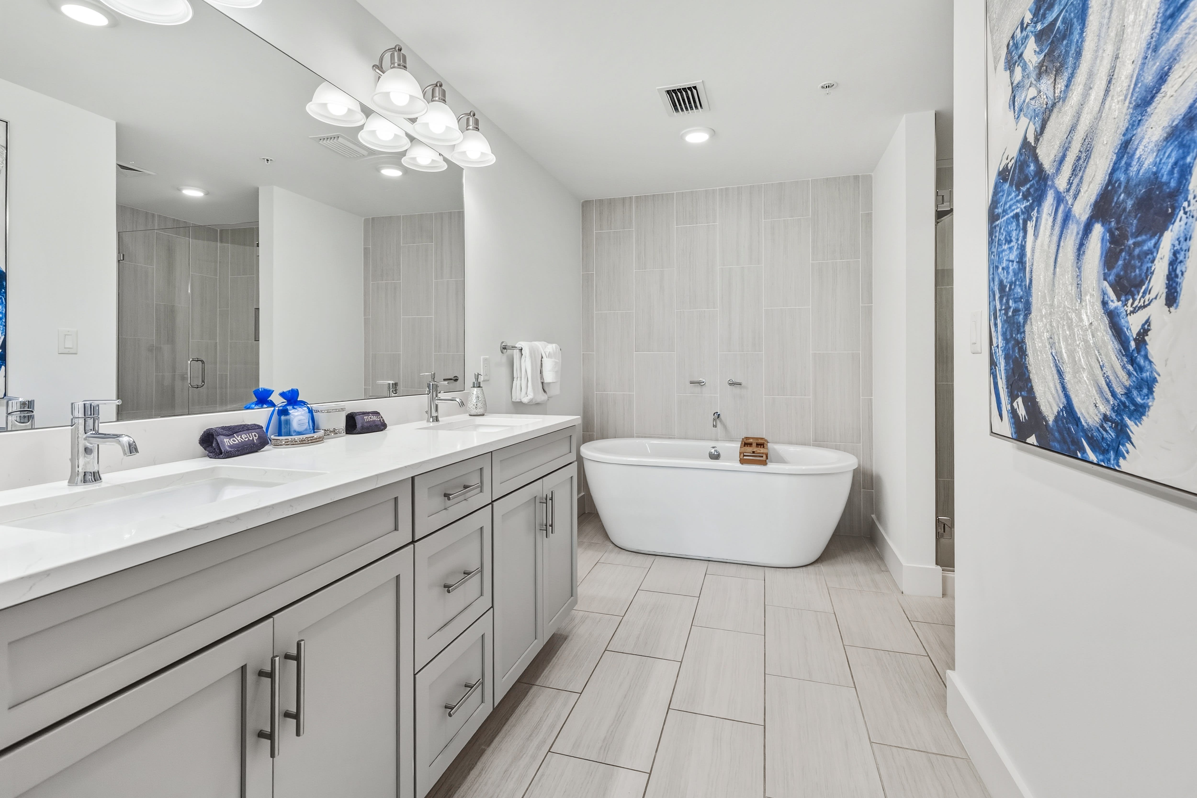 Unwind in your luxurious spa-like bathroom featuring a deep soaking tub and elegant vanity with modern finishes.