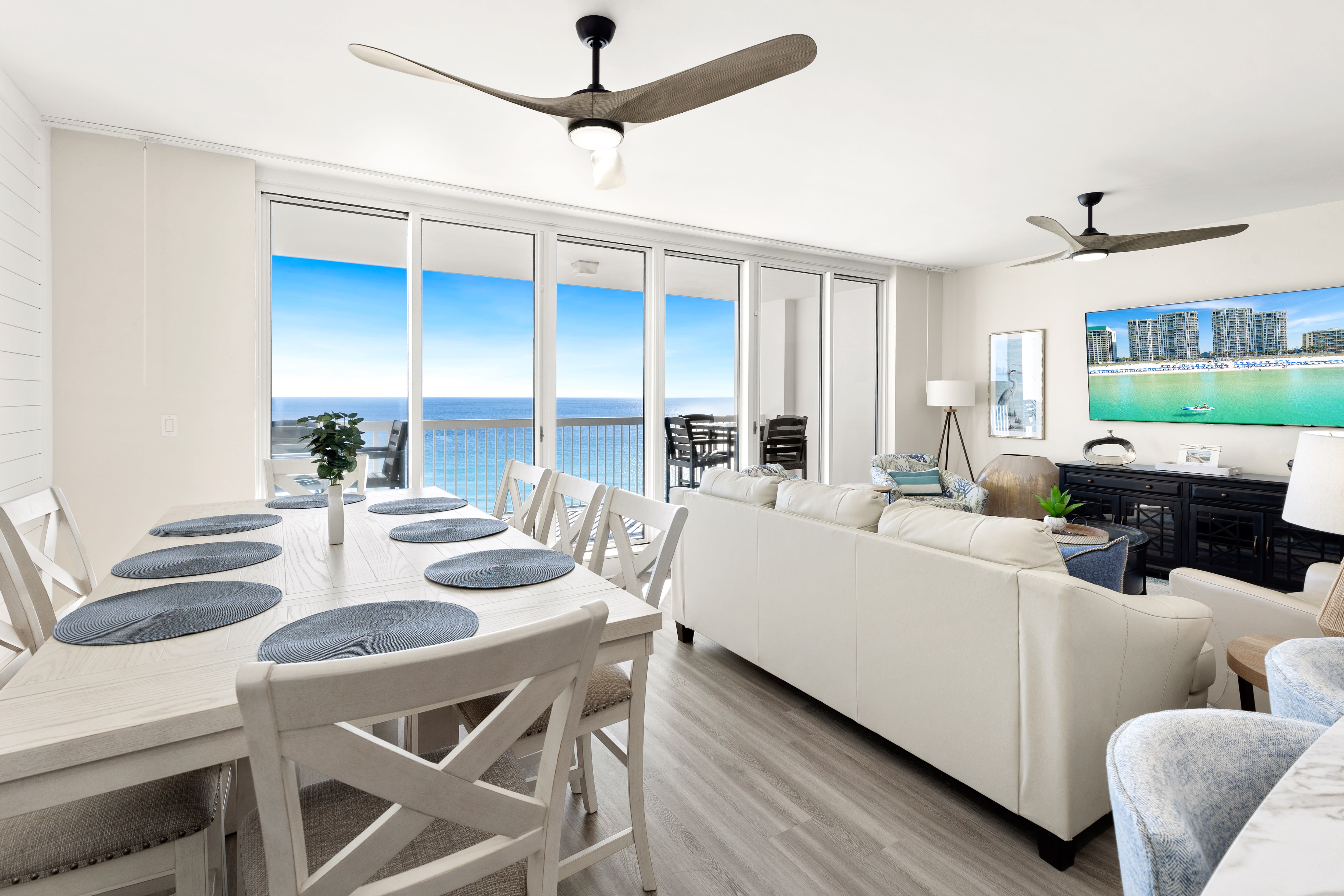 Relax in your bright oceanfront living space with stunning sea views through floor-to-ceiling windows.