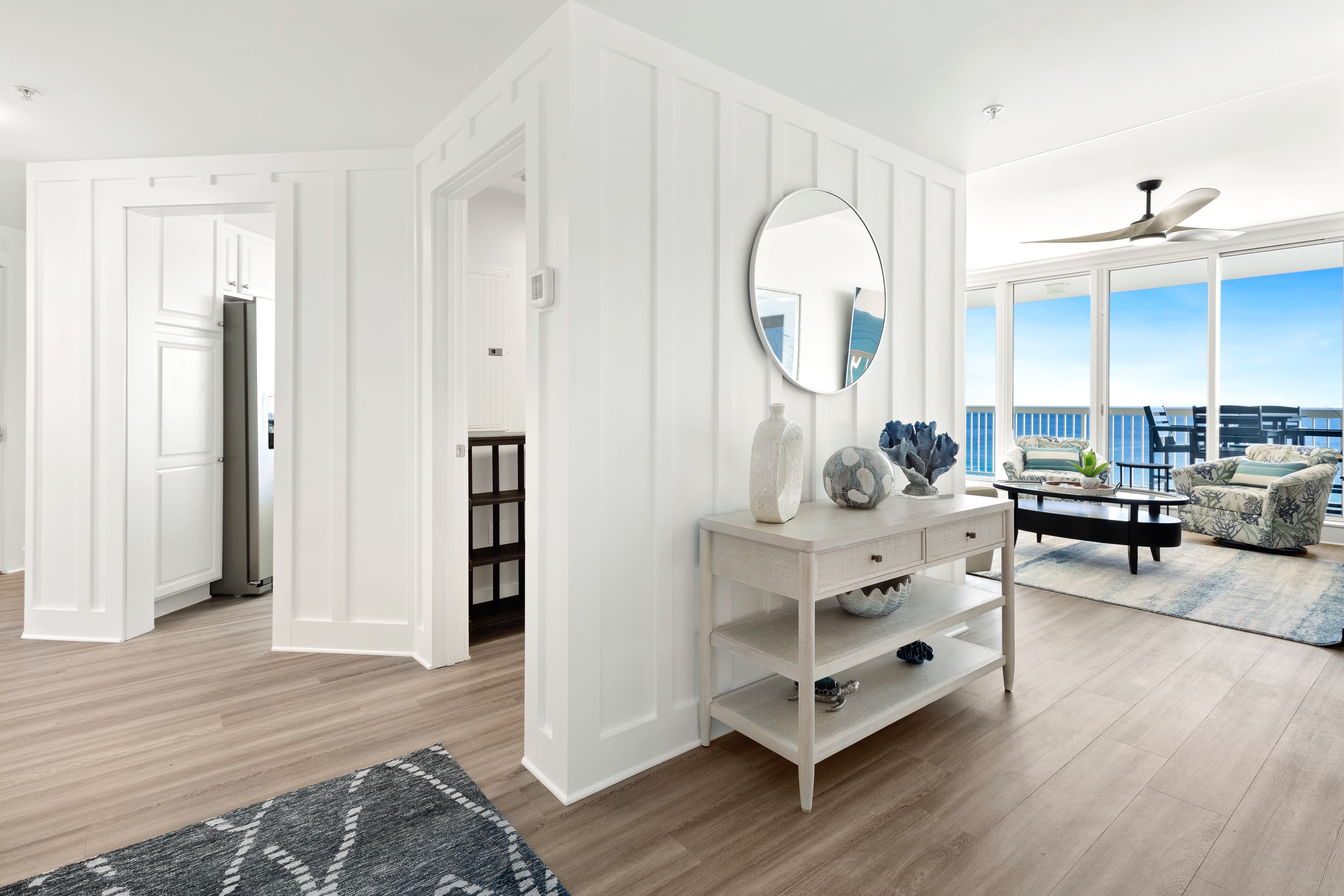 Step into your bright, coastal-inspired living space where ocean views and elegant furnishings create the perfect retreat.