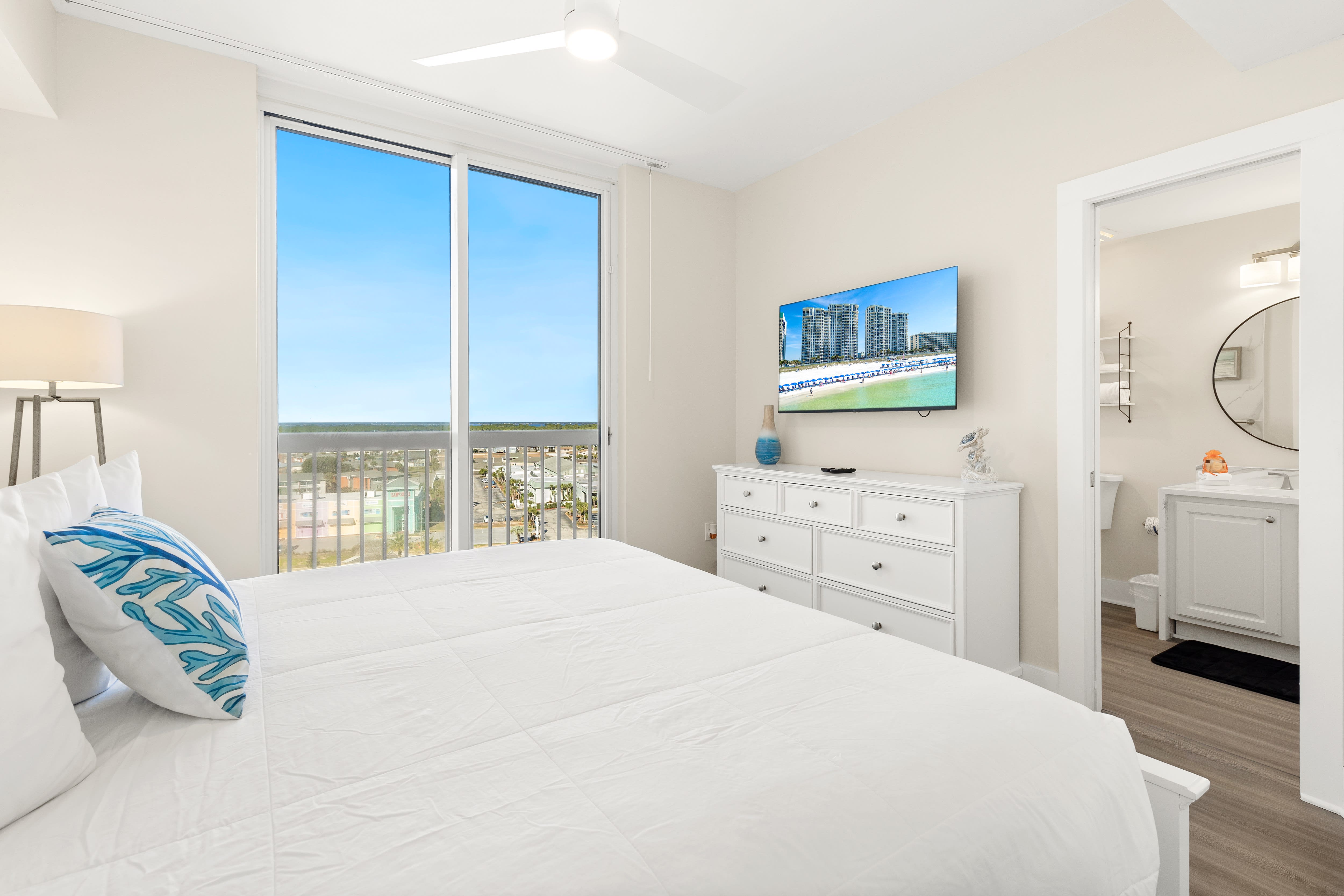 Wake up to stunning water views from your bright, coastal-themed bedroom with comfortable furnishings and peaceful mornings ahead.