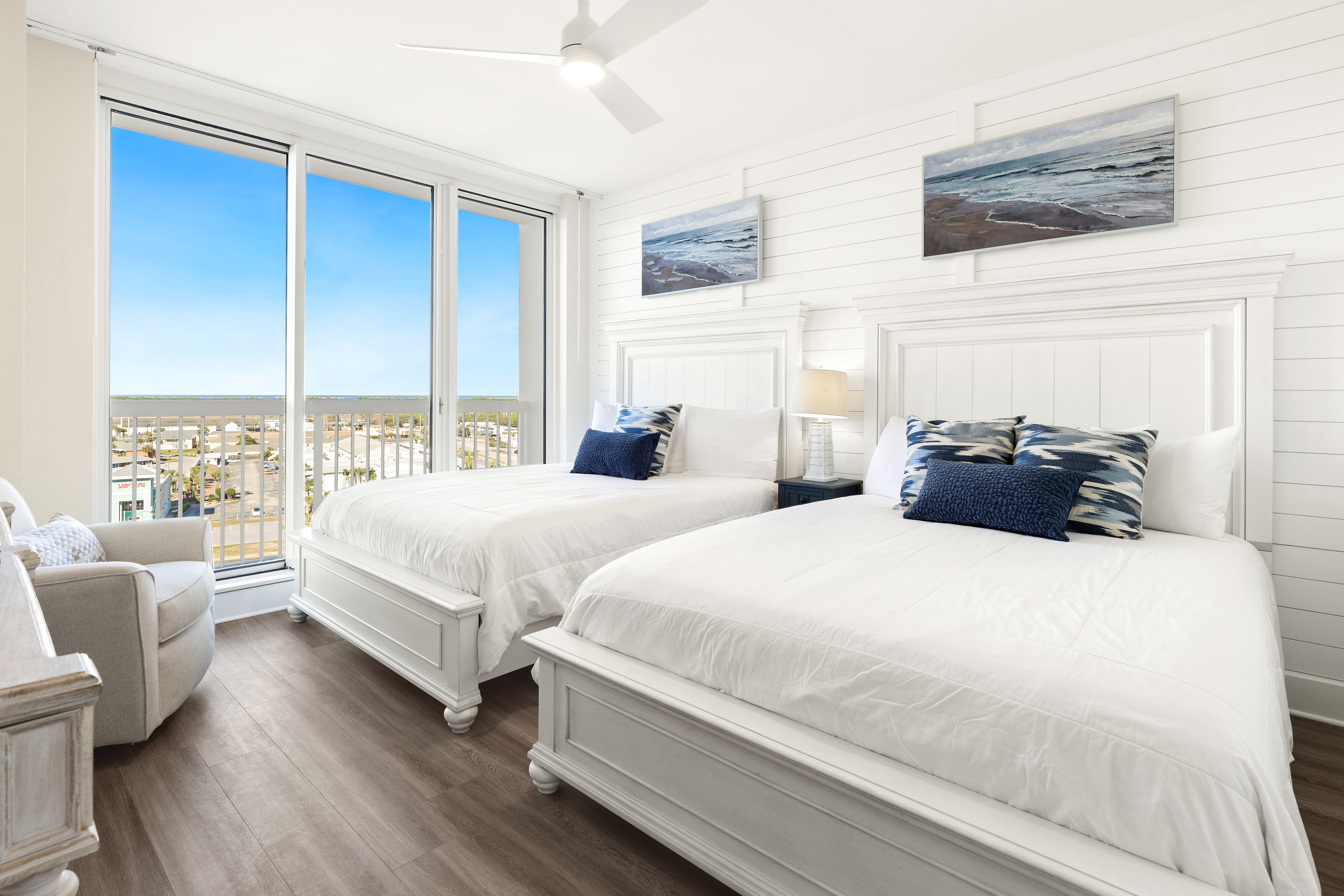 Wake up to stunning coastal views from your comfortable twin beds in this bright, airy bedroom with crisp white linens and nautical touches.