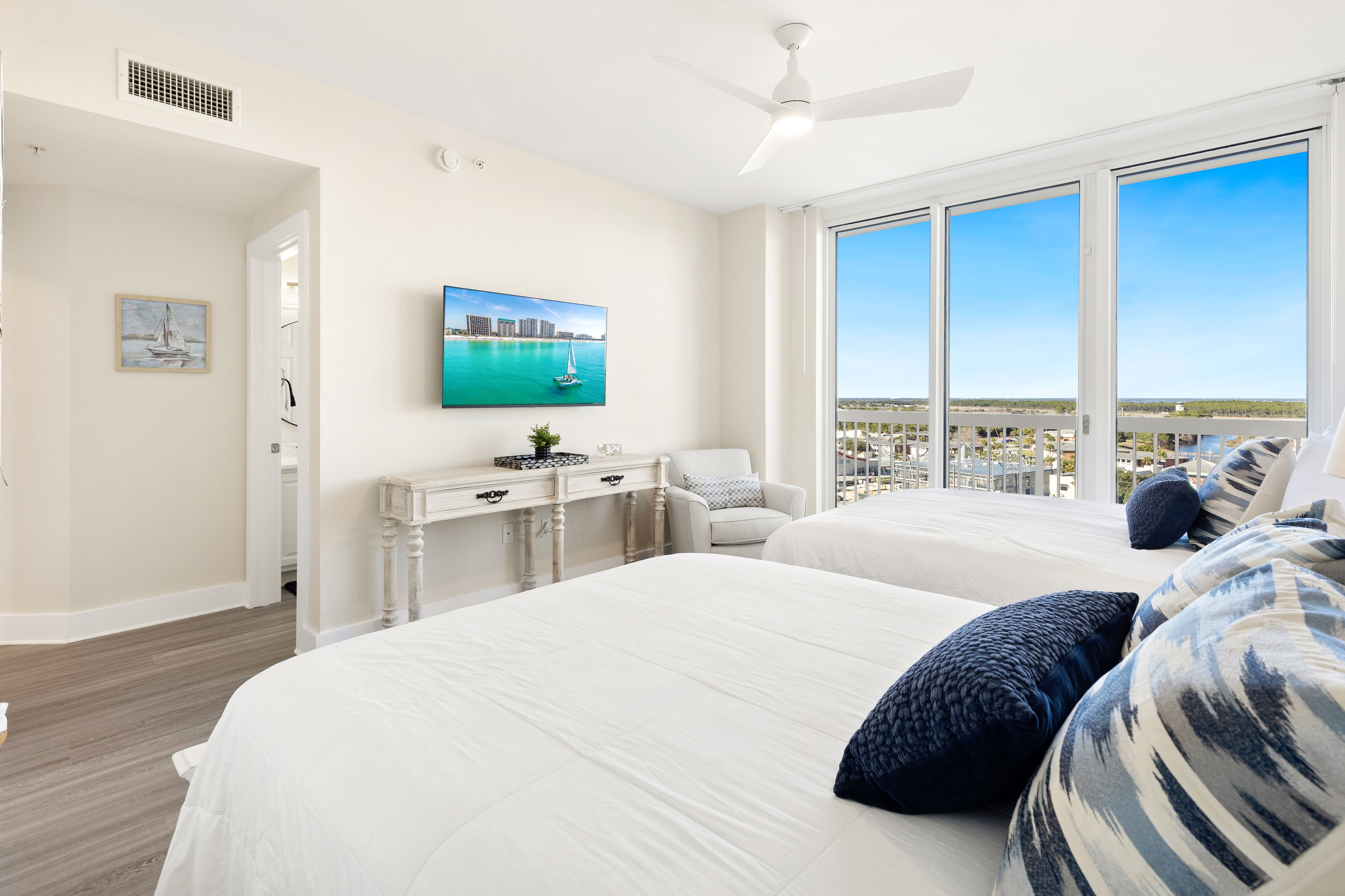 Wake up to stunning panoramic views from your bright, coastal-themed bedroom with crisp linens and modern comfort.