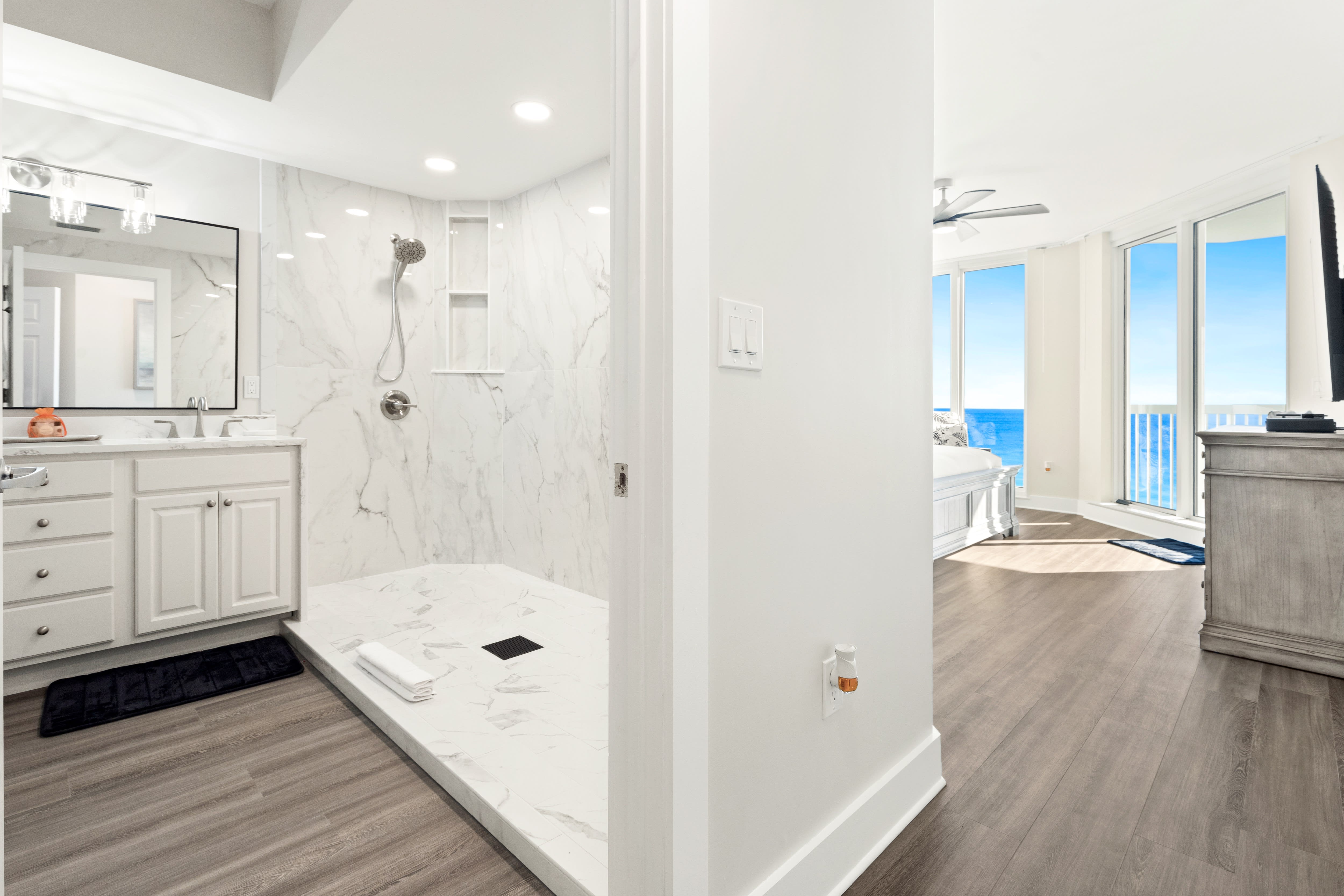 Indulge in your luxurious ensuite with marble shower and soaking tub, while ocean views beckon from your bedroom beyond.