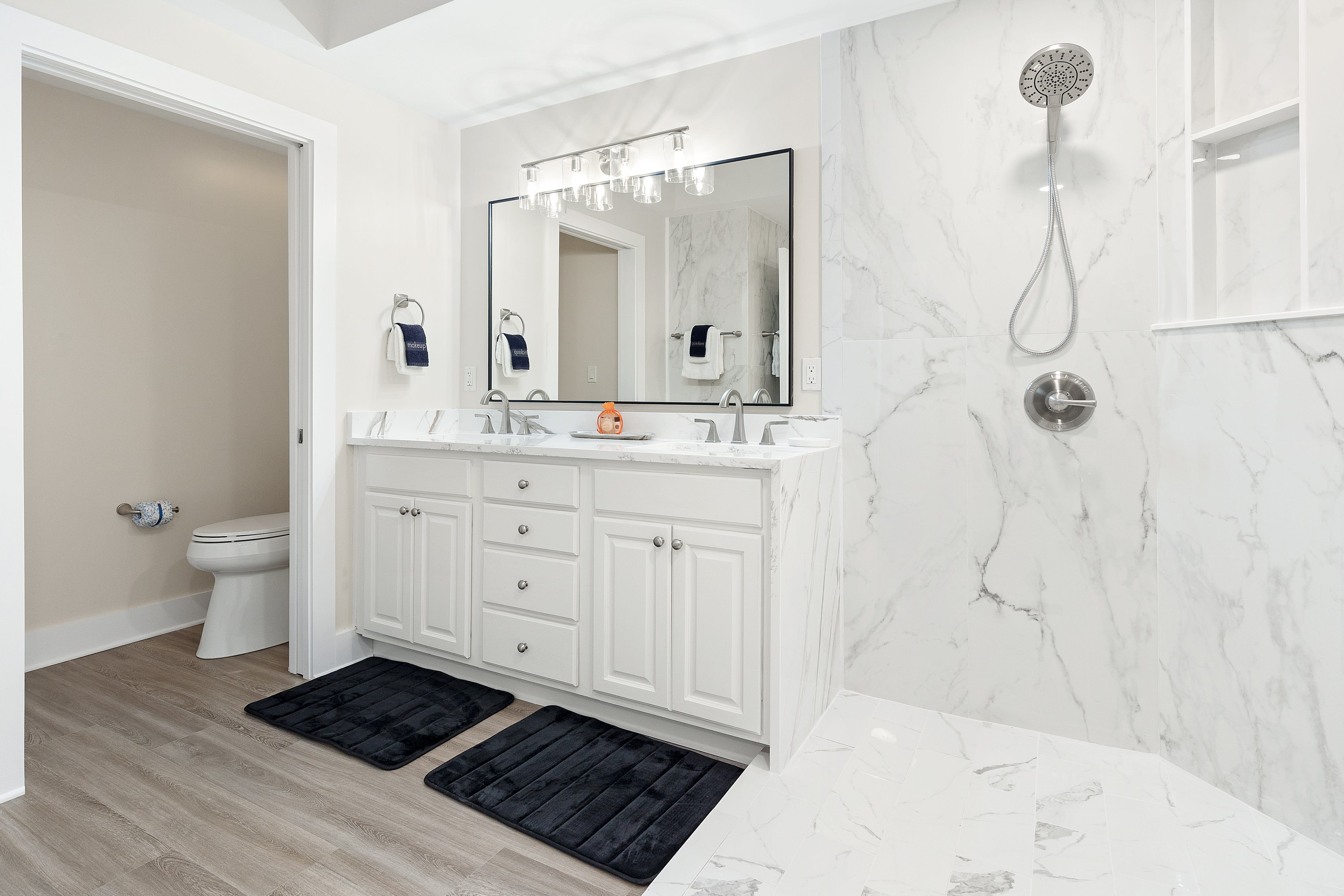 Luxurious marble bathroom with spacious walk-in shower and elegant double vanity for your morning routine.
