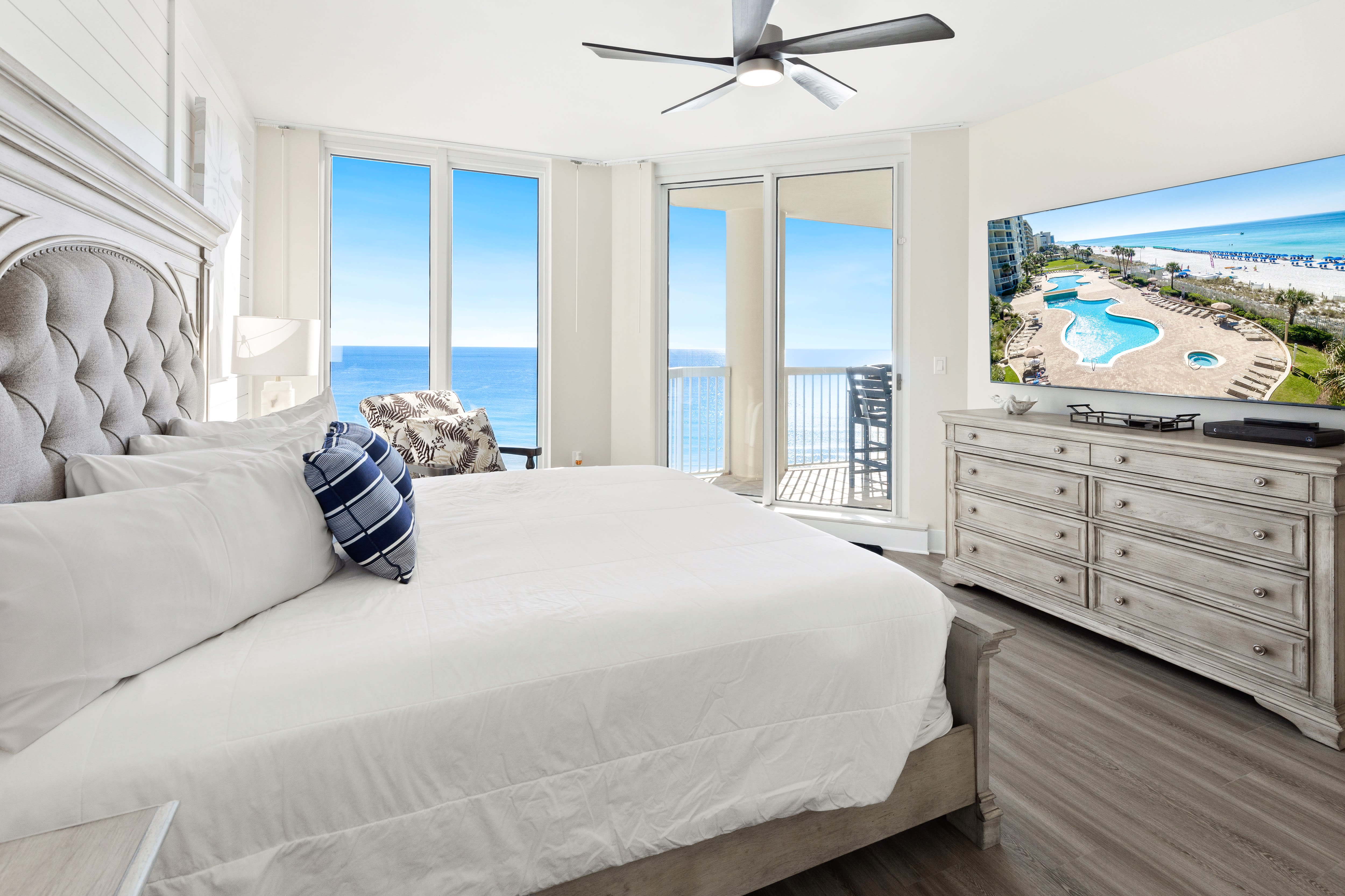 Wake up to breathtaking ocean views from your elegant bedroom, where luxury bedding meets stunning sea vistas through expansive windows.