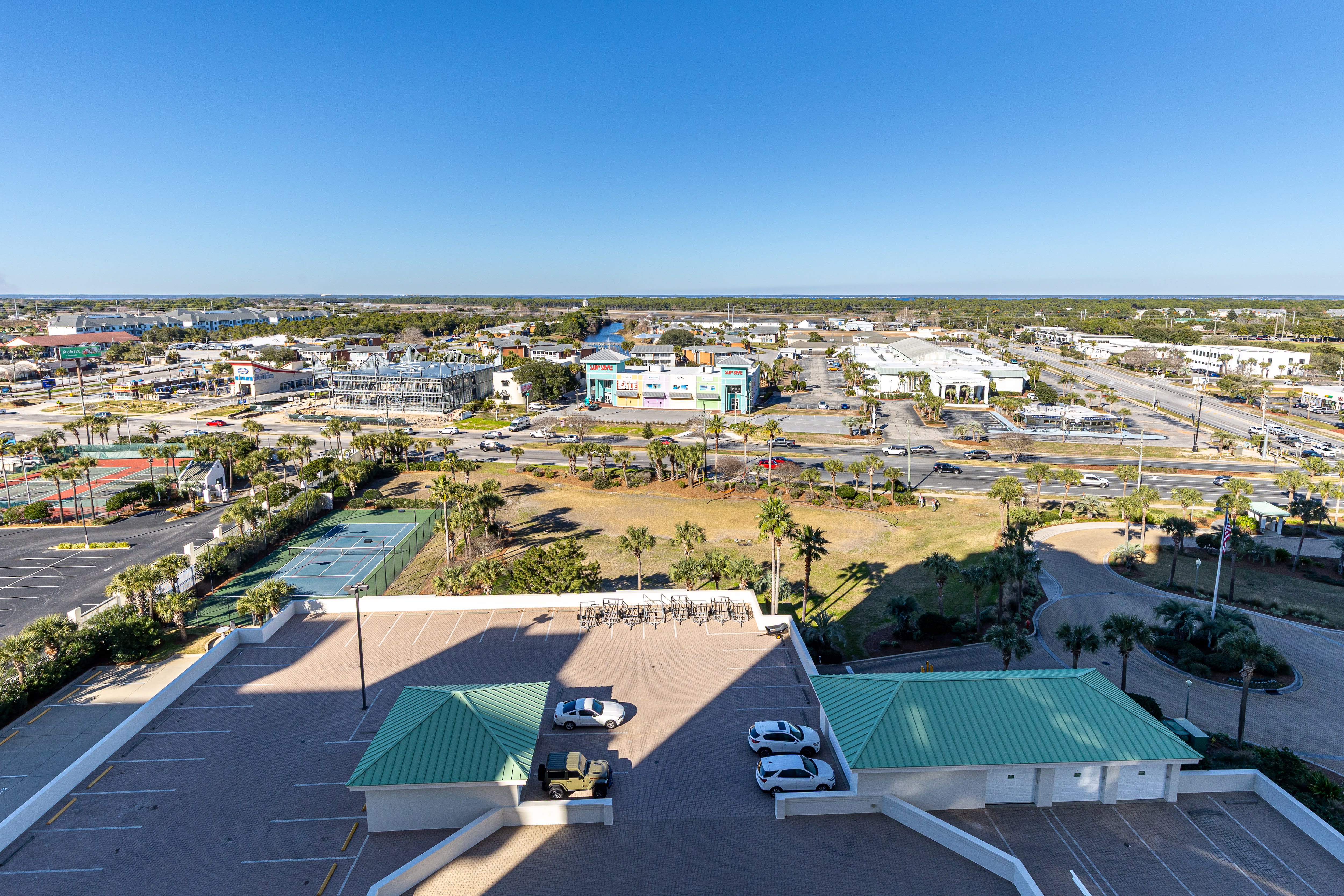 Aerial view of the property showcasing a convenient location with nearby tennis courts, shopping centers, and easy access to local amenities.