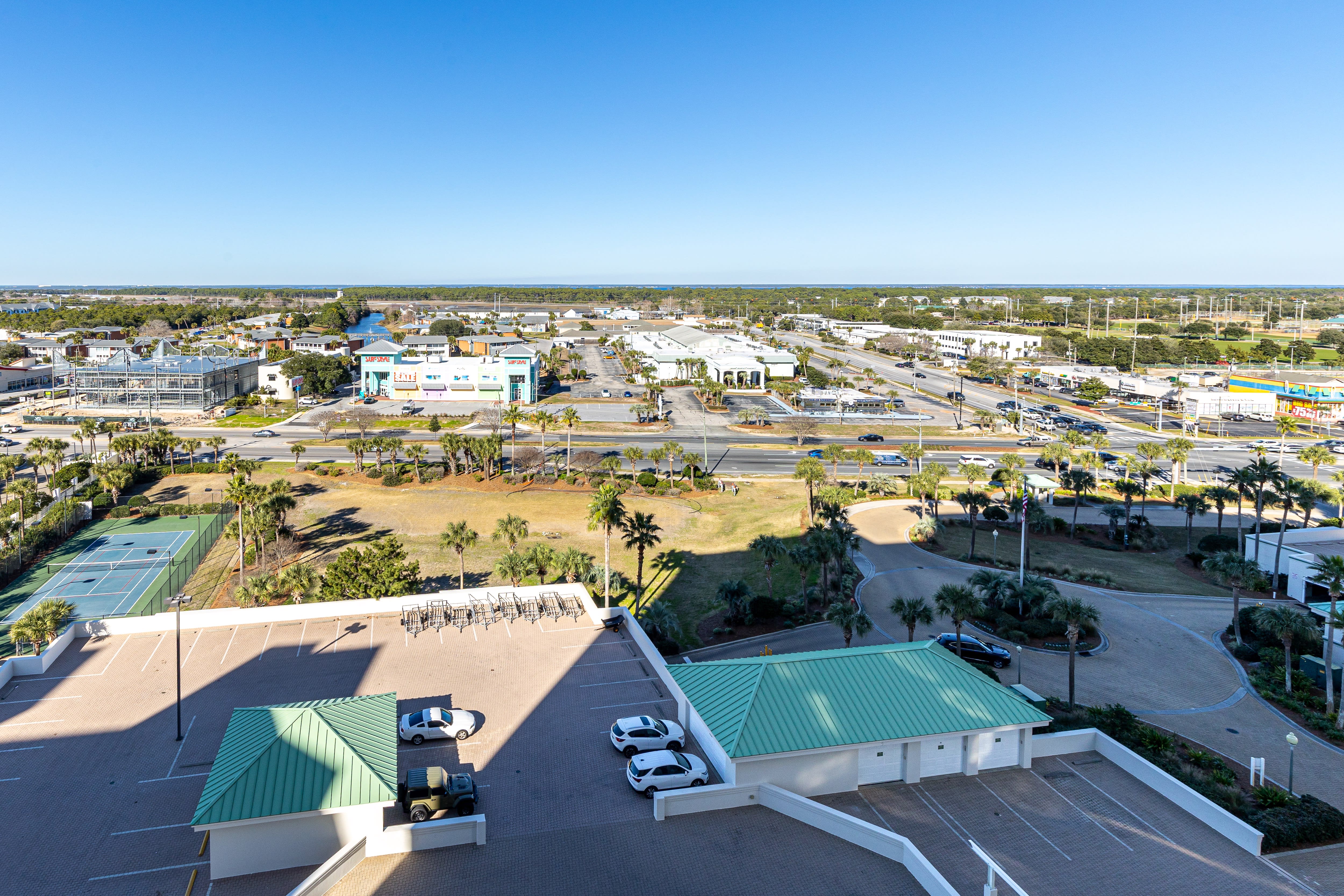 Aerial view showcasing the property's prime location within a vibrant coastal community, surrounded by recreational facilities and local amenities.