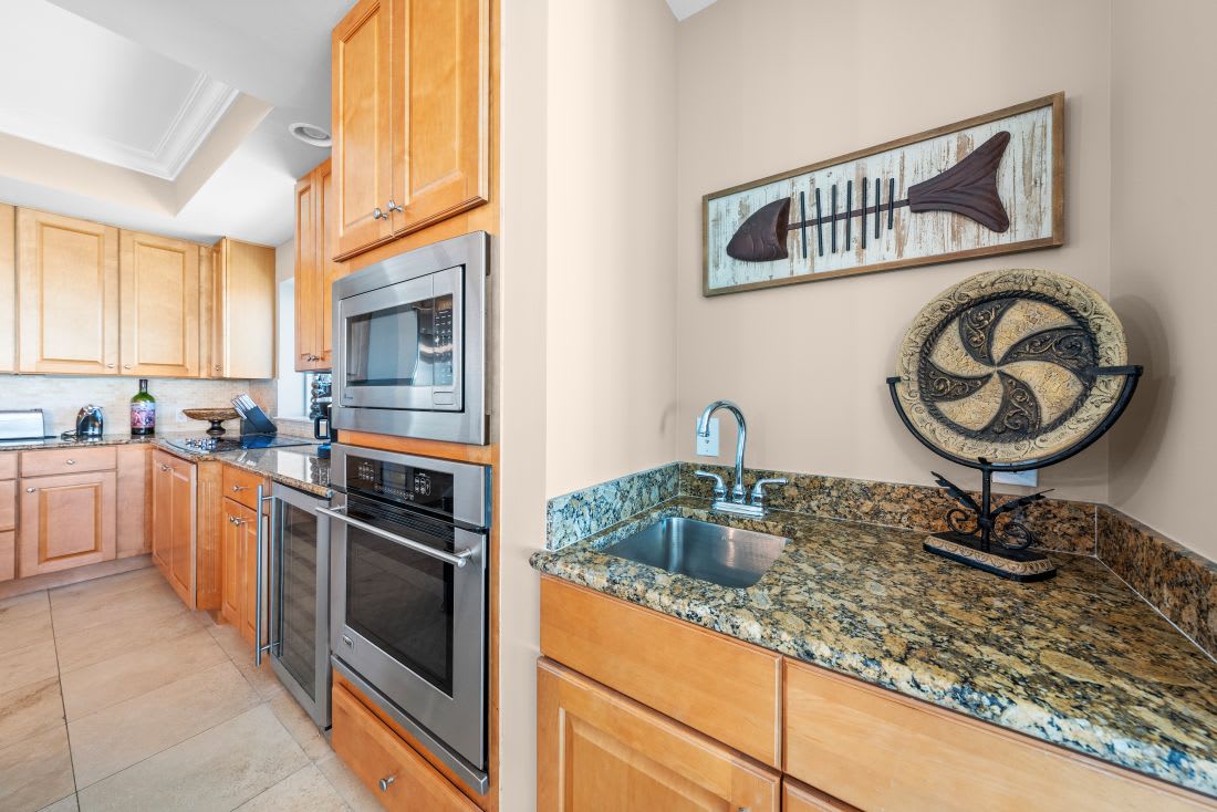 Prepare your favorite meals in this fully equipped kitchen with granite counters, stainless appliances, and ocean-inspired décor.