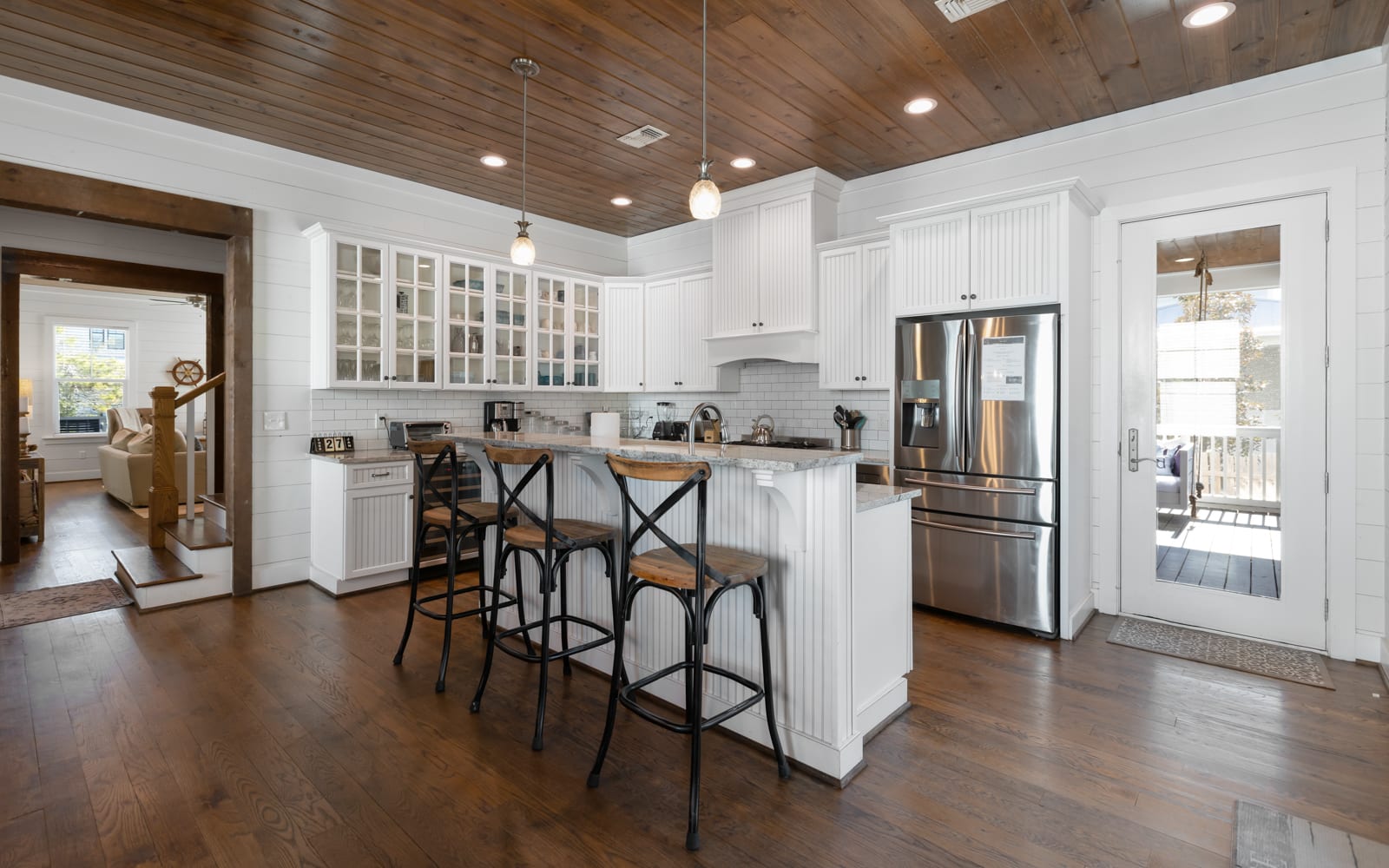 Your dream kitchen awaits with gleaming granite countertops, premium stainless appliances, and charming rustic wood ceiling beams overhead.