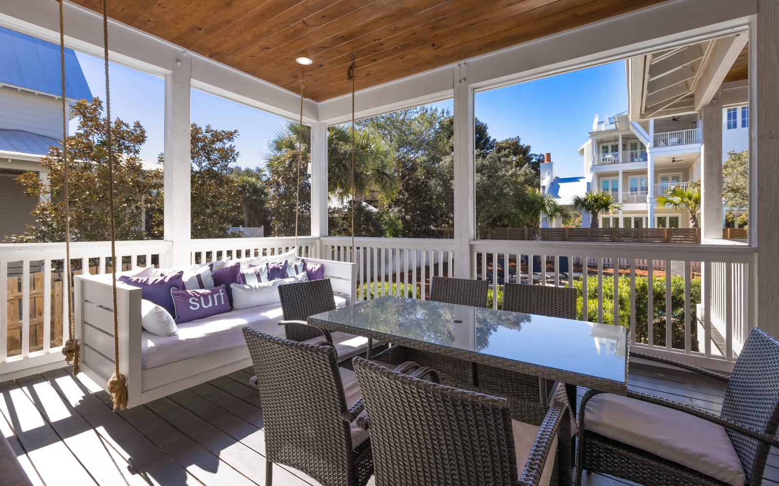 Your private screened balcony awaits with a cozy daybed swing and dining for six—perfect for morning coffee or evening meals.
