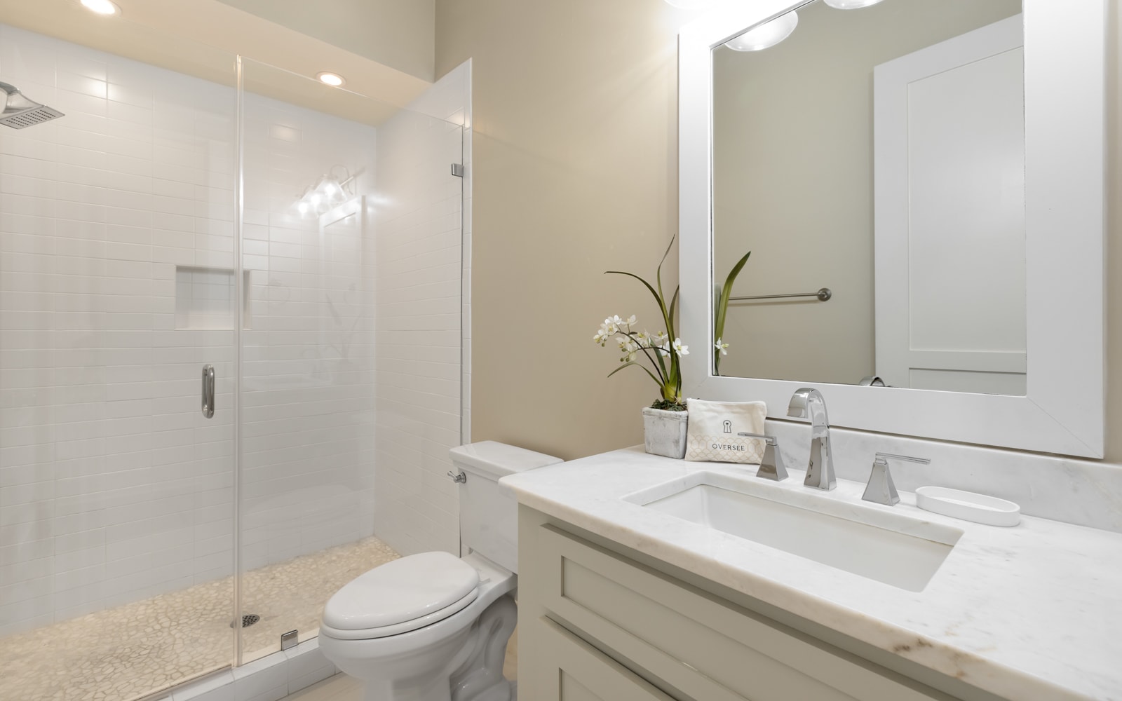Step into your pristine bathroom where marble countertops and a spacious glass shower create a spa-like retreat for your daily rituals.