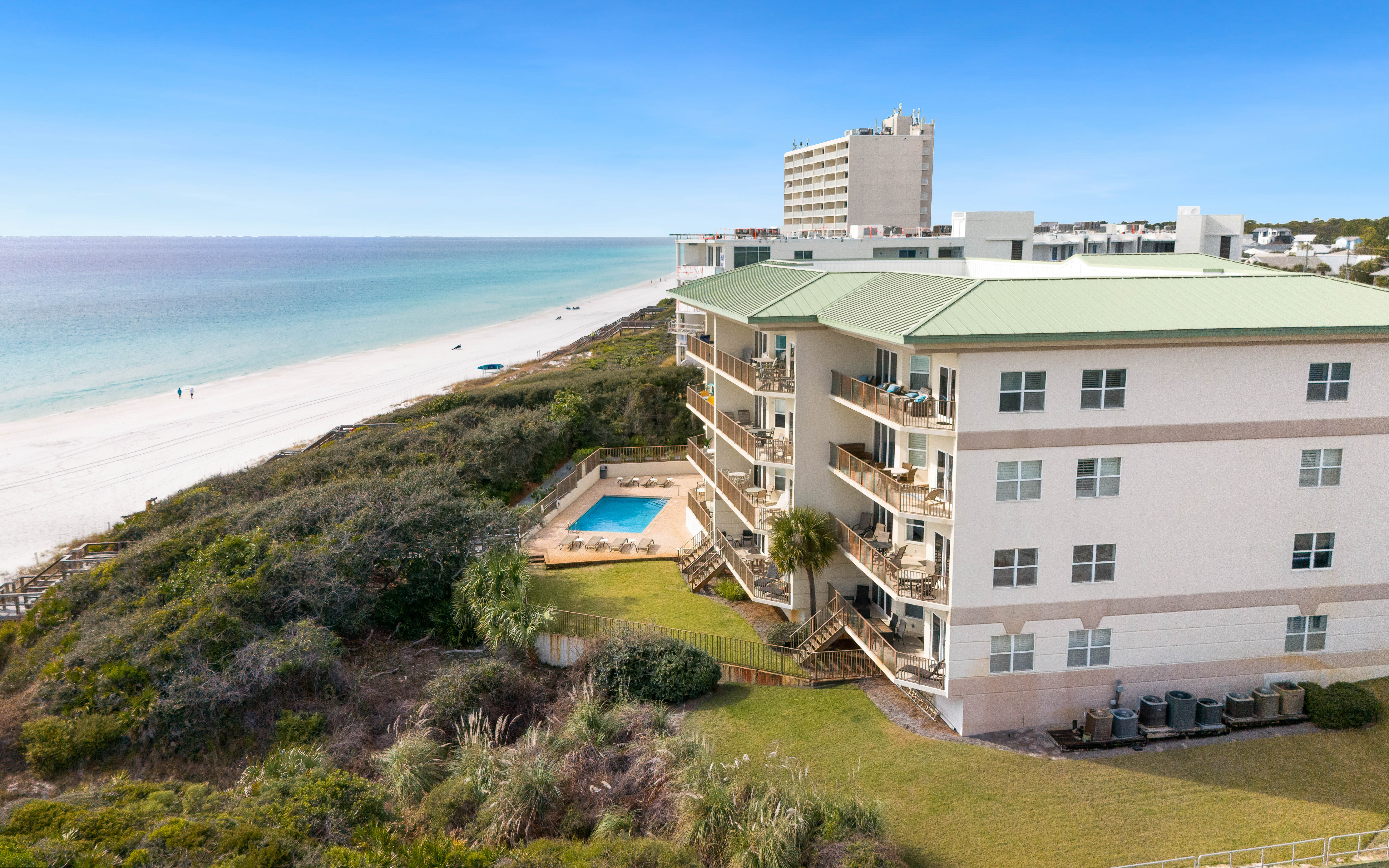 Beachfront property featuring pristine white sand beach access, swimming pool, and stunning coastal location.