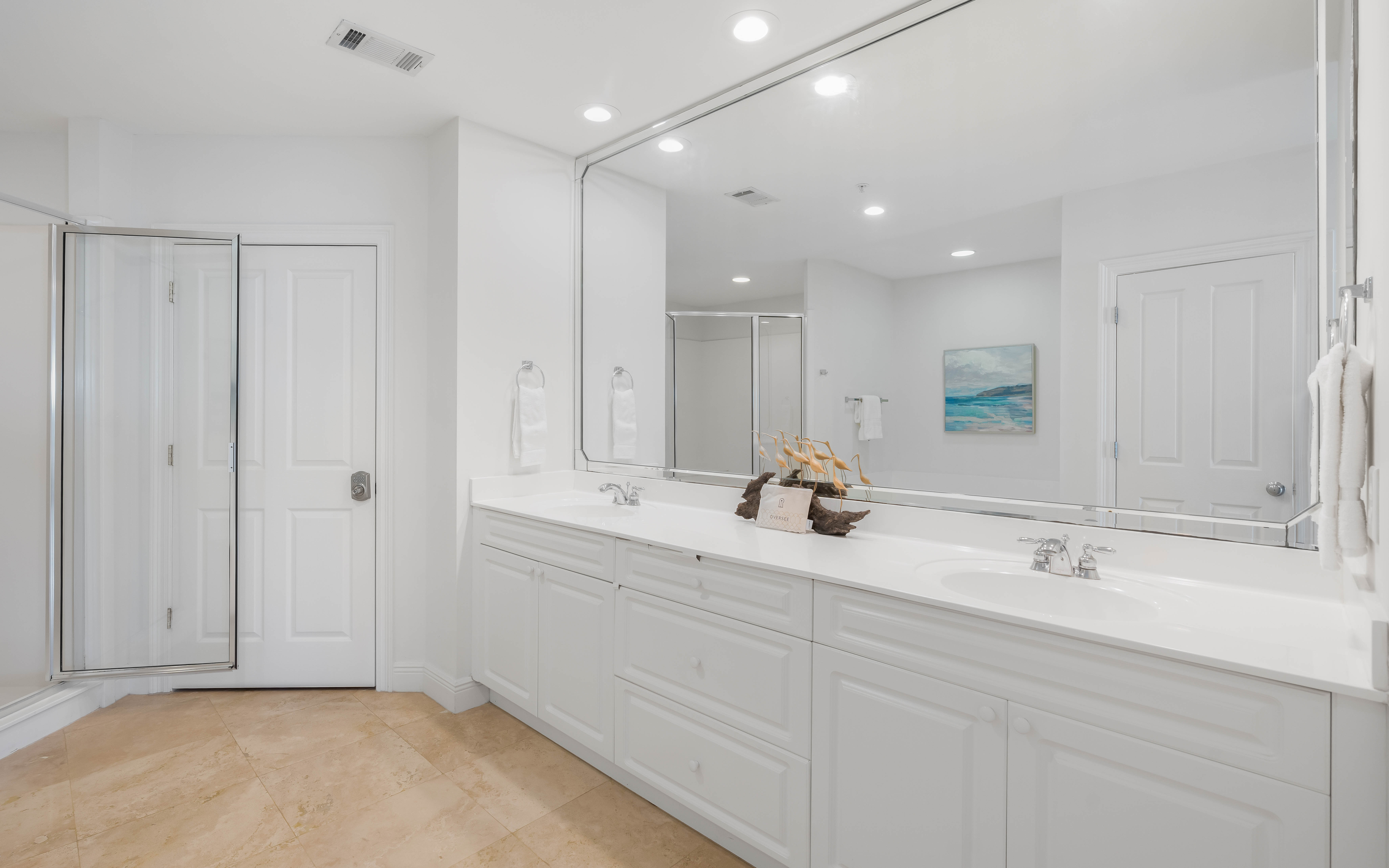Step into your luxurious master bathroom with dual vanities, pristine white finishes, and spa-like ambiance perfect for morning routines.