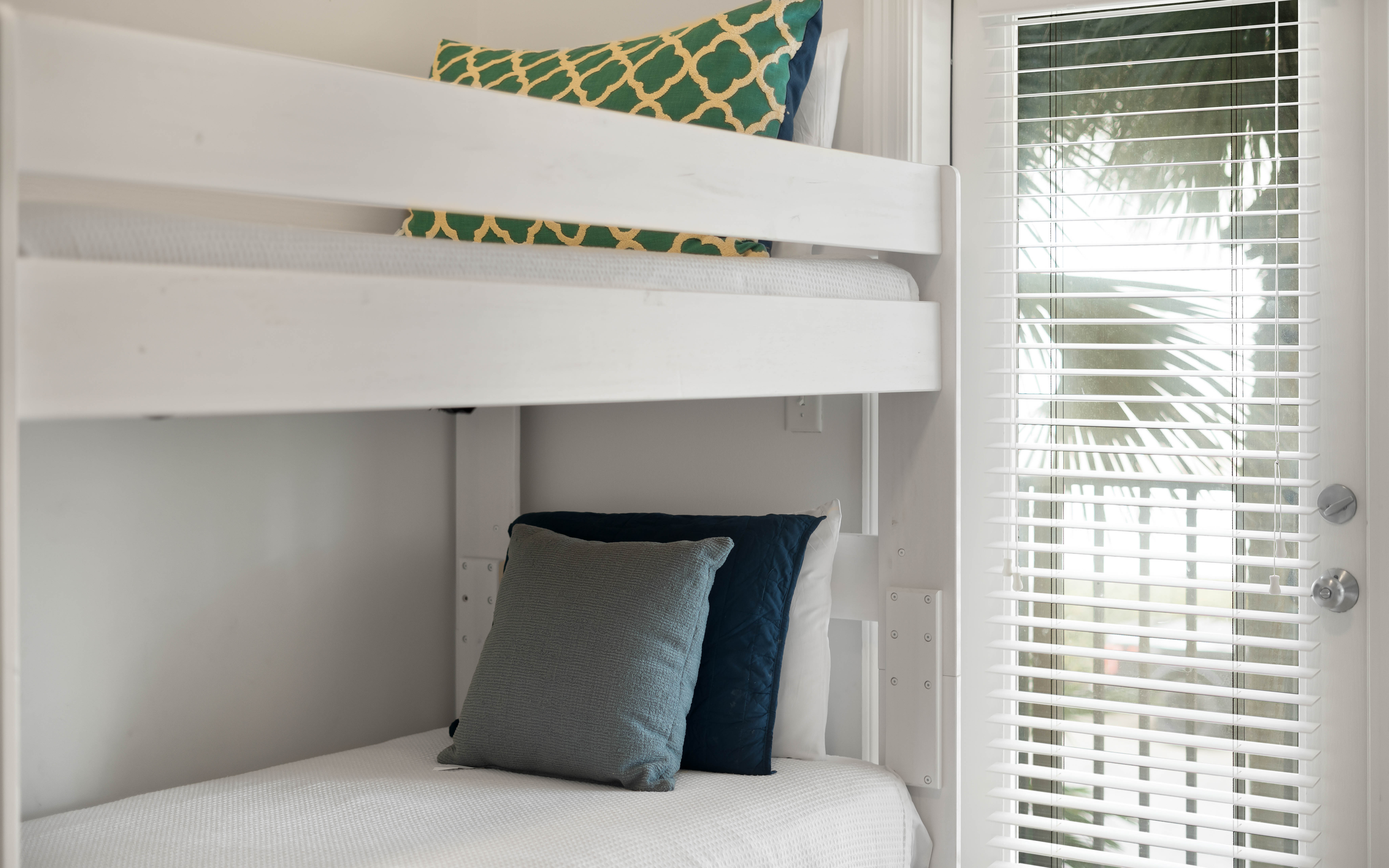 Your cozy bunk bed setup offers comfortable sleeping with stylish pillows and fresh linens, perfect for family stays.