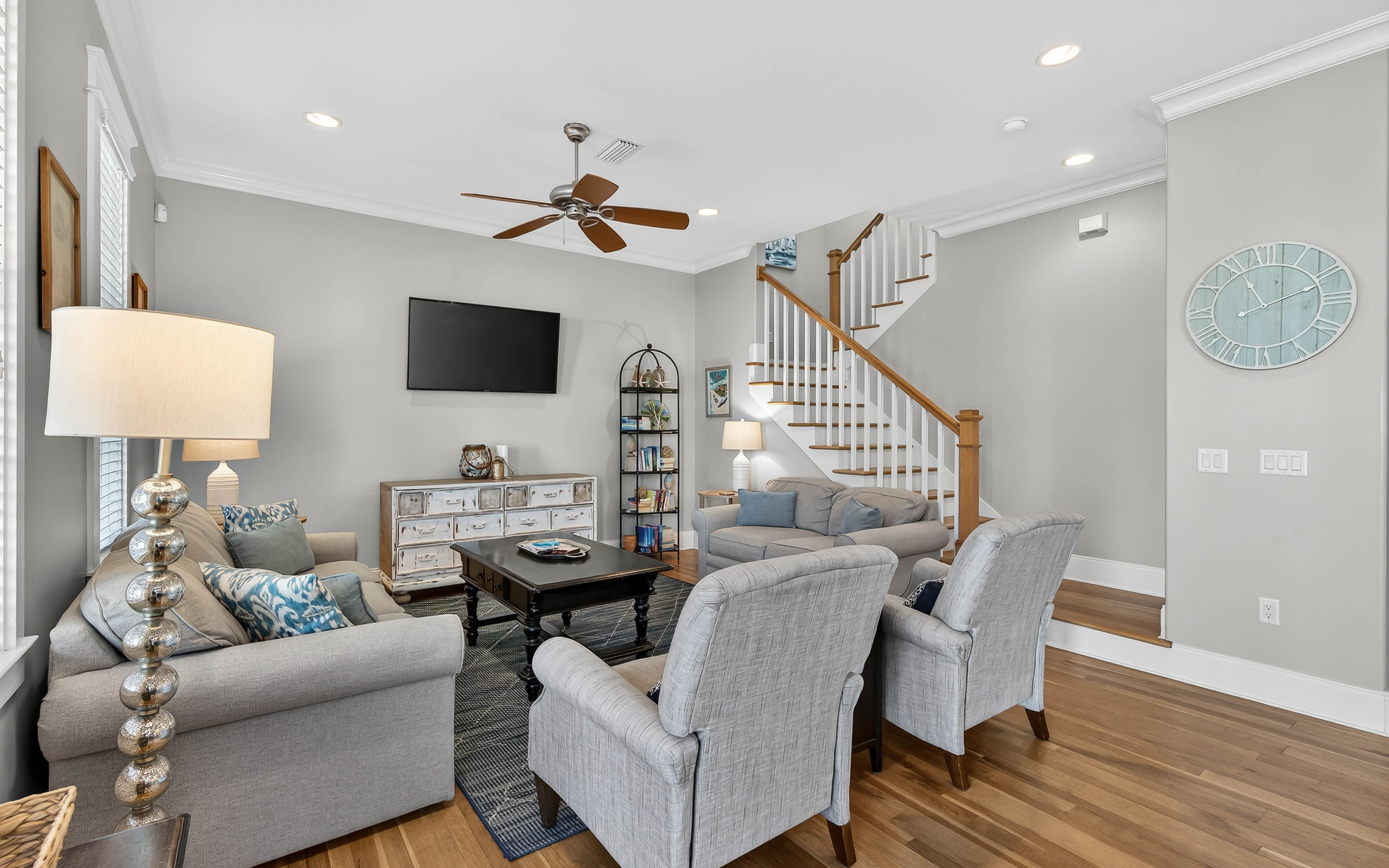Relax in this bright living space with plush seating, warm wood floors, and coastal-inspired decor that welcomes you home.