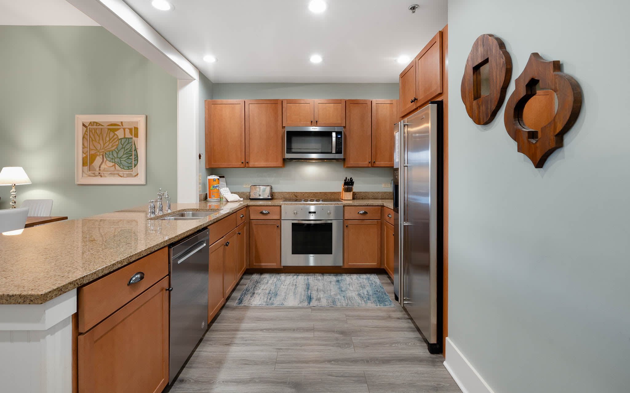 Your modern kitchen features granite countertops, stainless steel appliances, and warm wood cabinets perfect for preparing memorable meals.