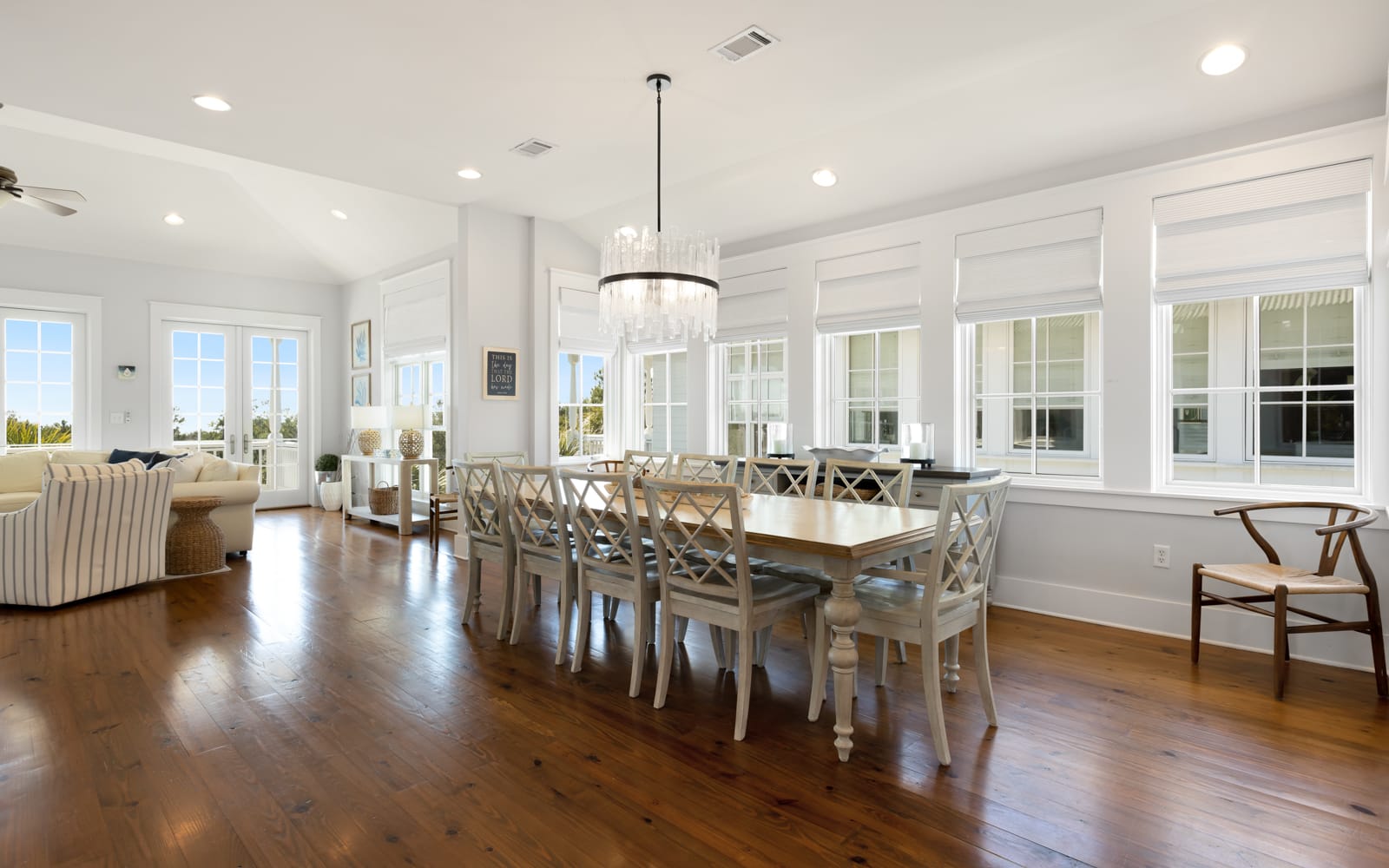 Gather around this elegant dining table where warm hardwood floors and crystal chandelier create perfect moments for your memorable meals together.