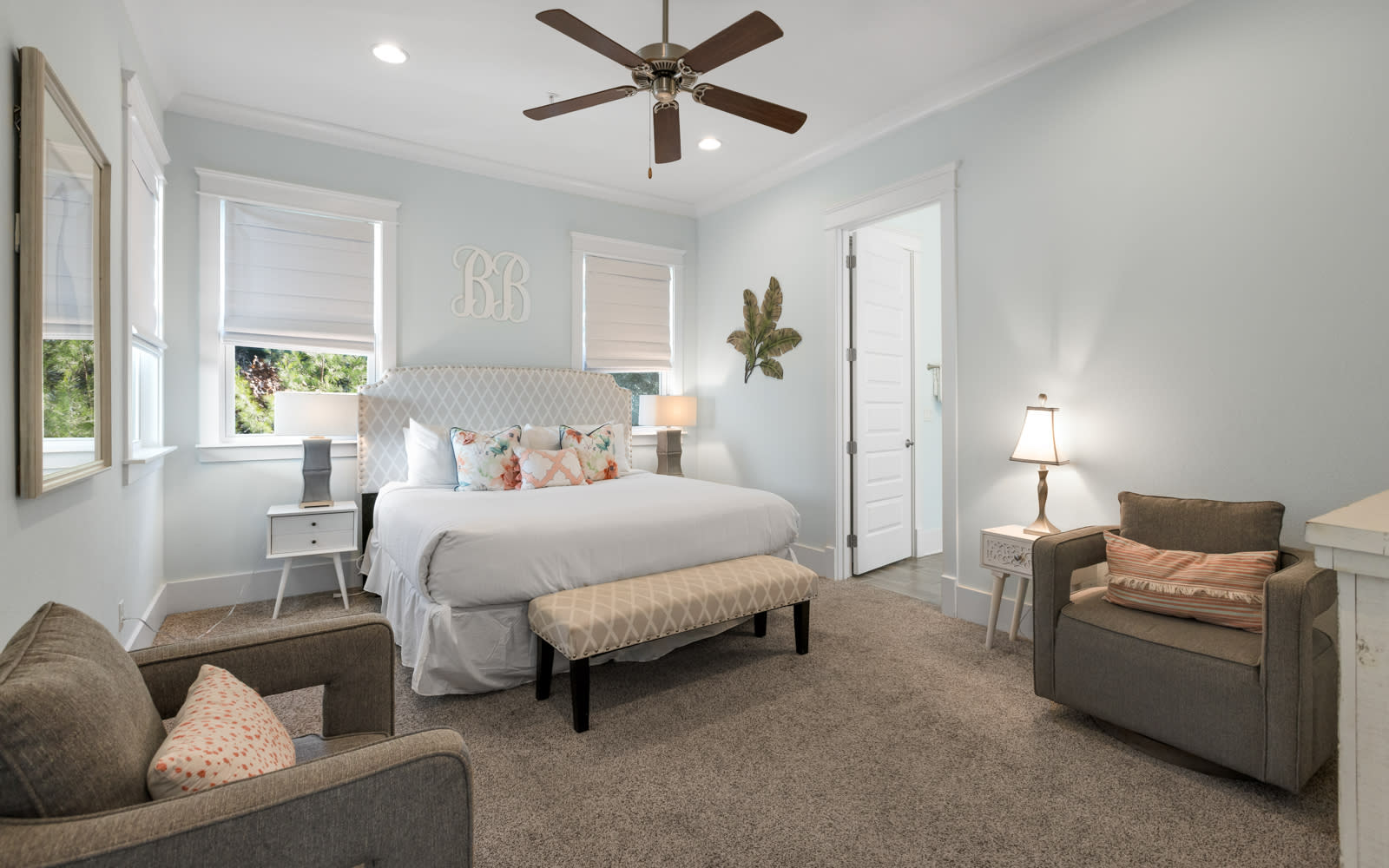 Sink into this serene bedroom where soft linens and plush seating create your perfect retreat after exploring the area.