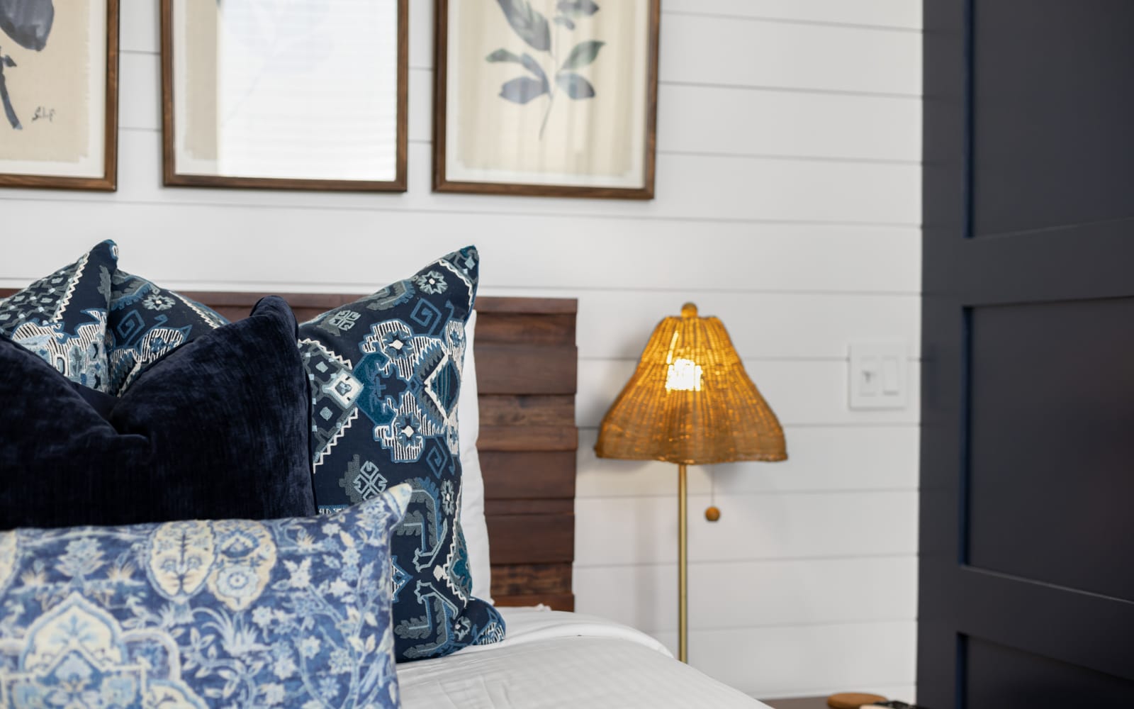 Sink into your comfortable bed adorned with beautiful blue patterned pillows and soft lighting that creates the perfect ambiance for relaxation.