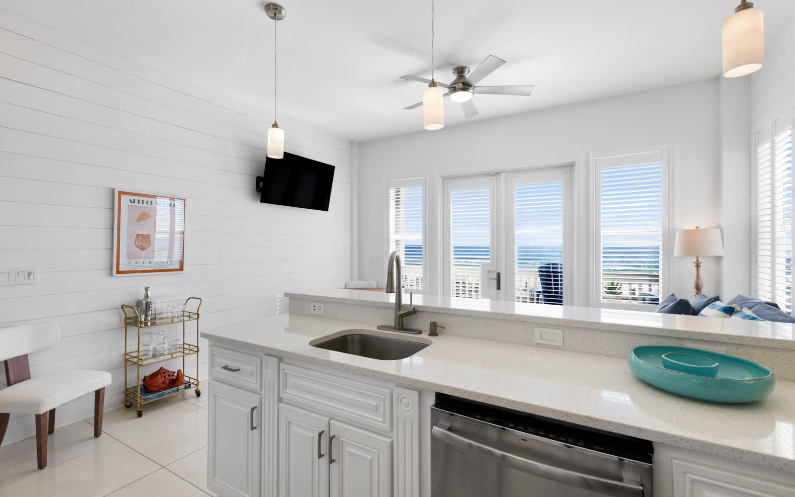 Your bright coastal kitchen offers modern appliances and stunning ocean views, perfect for morning coffee while watching waves roll in.