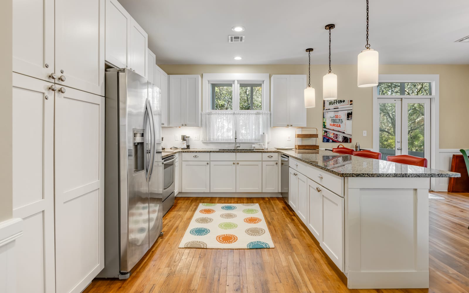 Cook your favorite meals in this bright, fully-equipped kitchen with granite countertops and modern appliances.