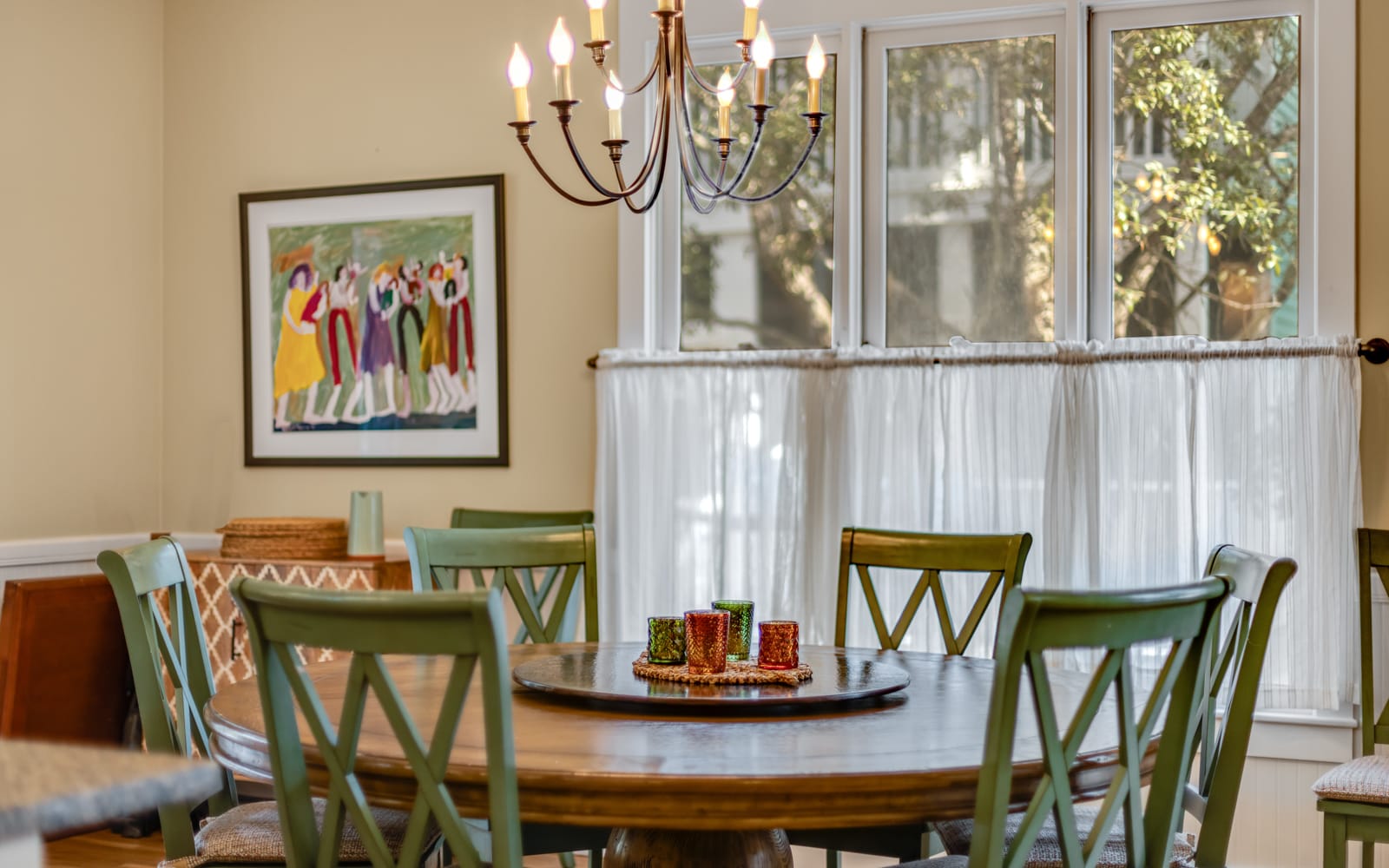 Gather around your elegant dining table where warm chandelier light creates the perfect ambiance for memorable meals with loved ones.