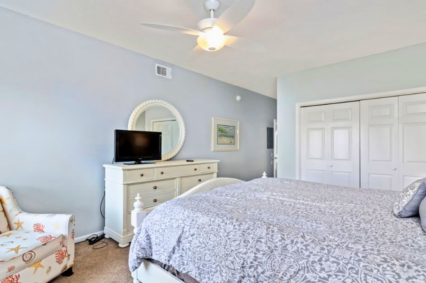 Drift into peaceful dreams in your serene bedroom with soft linens, gentle ceiling fan, and calming coastal colors creating the perfect retreat.