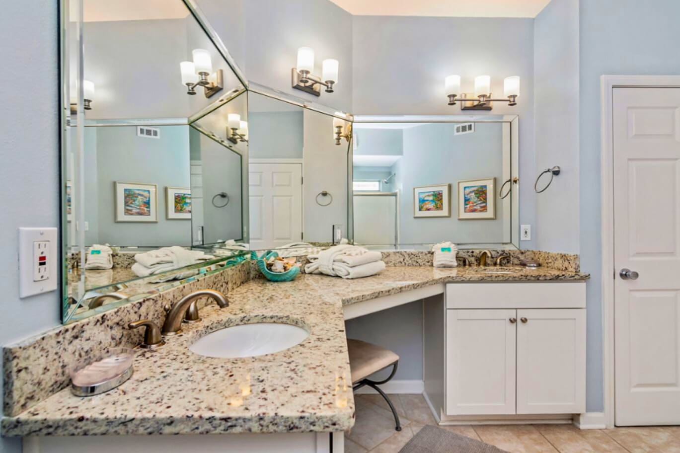 Luxurious granite vanity with dual sinks offers you ample space to prepare for your day in this elegantly appointed bathroom.