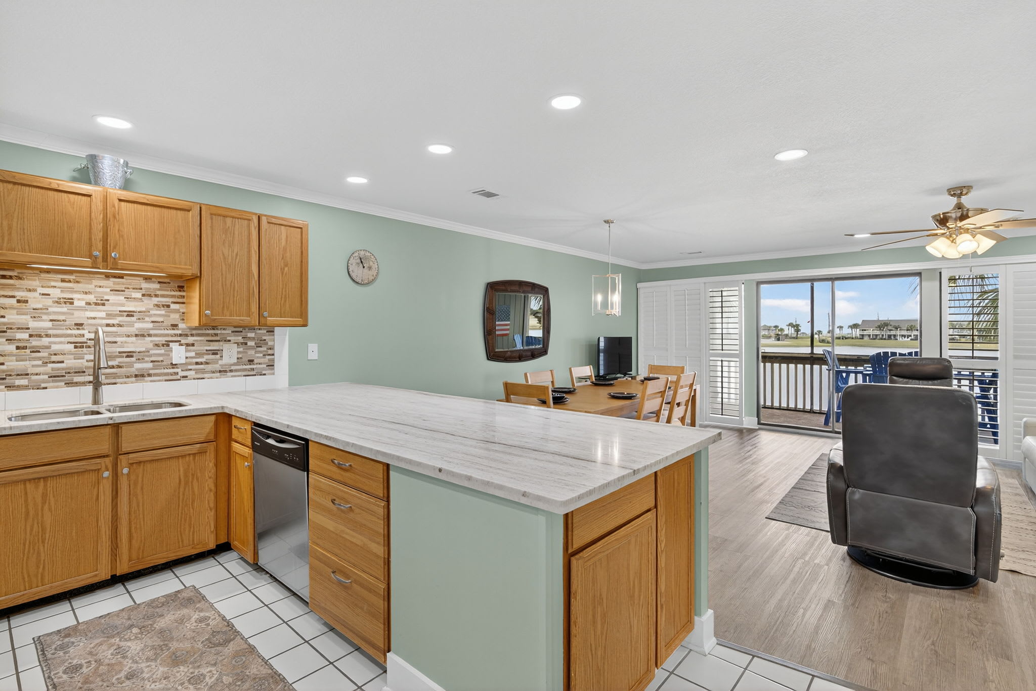 Open-concept living with a spacious kitchen featuring granite countertops and island, flowing seamlessly into your dining and living areas with balcony access.