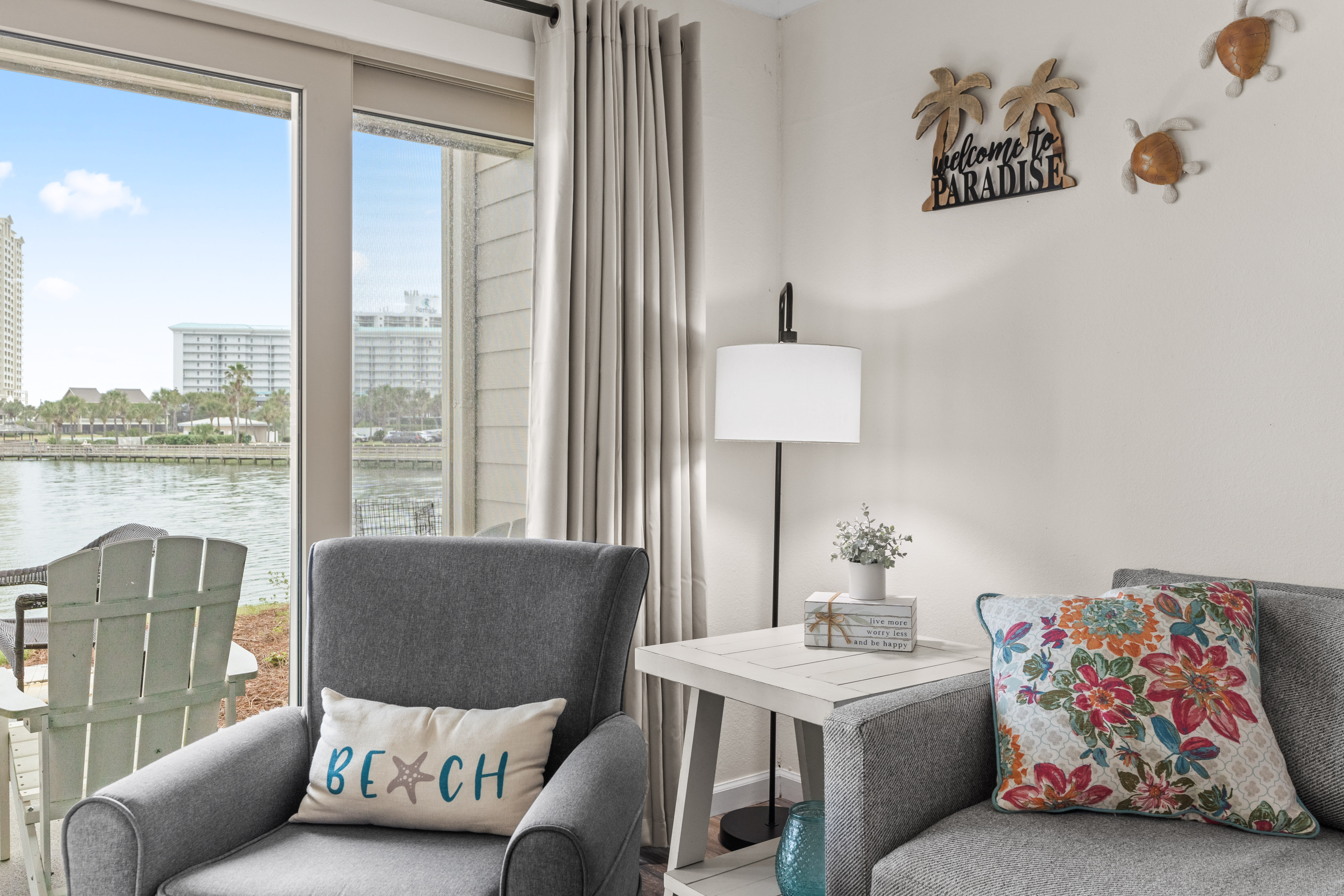 Settle into your waterfront paradise with coastal charm and stunning lake views from your cozy seating area.