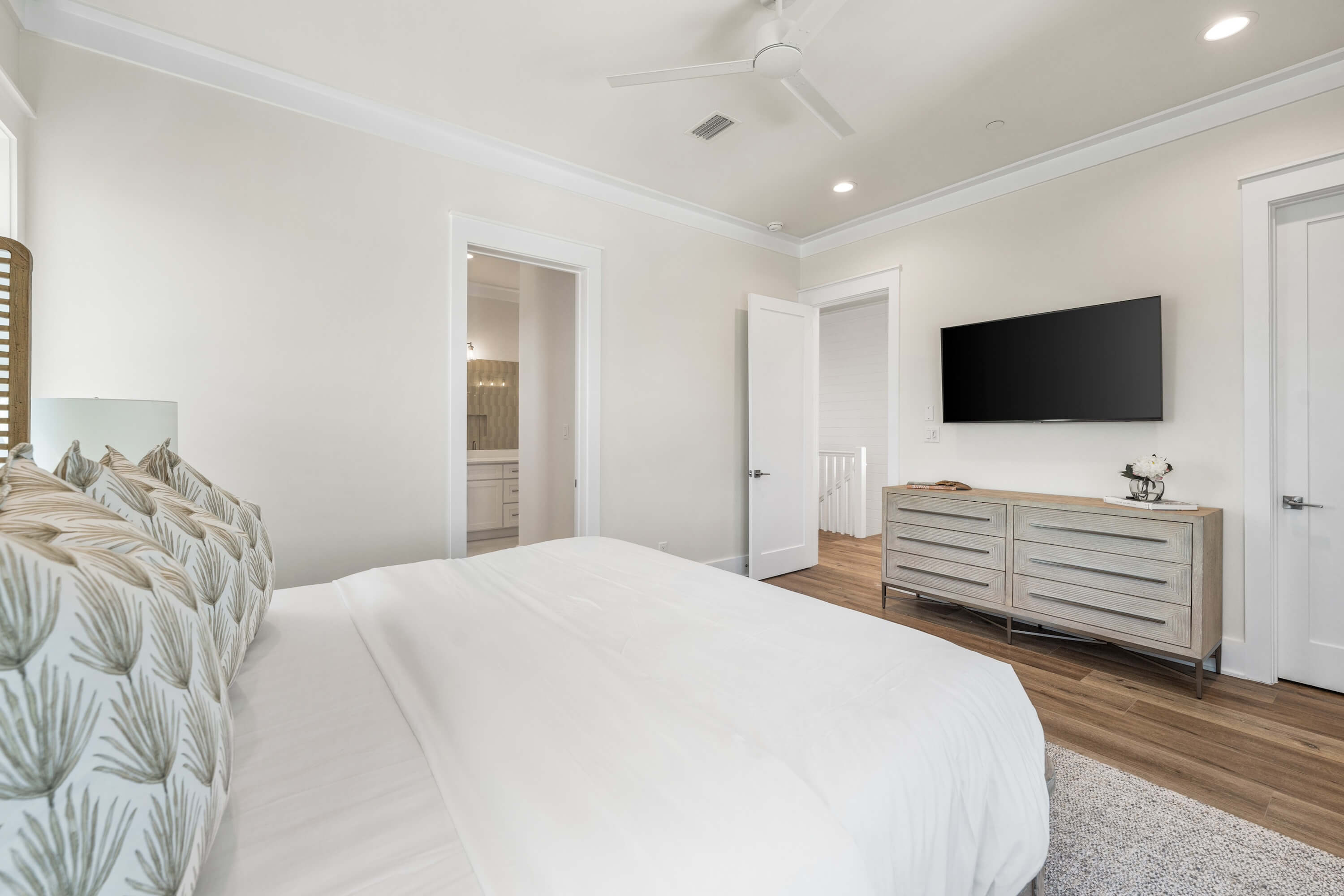 Features a smart TV, ceiling fan, and ensuite bath
