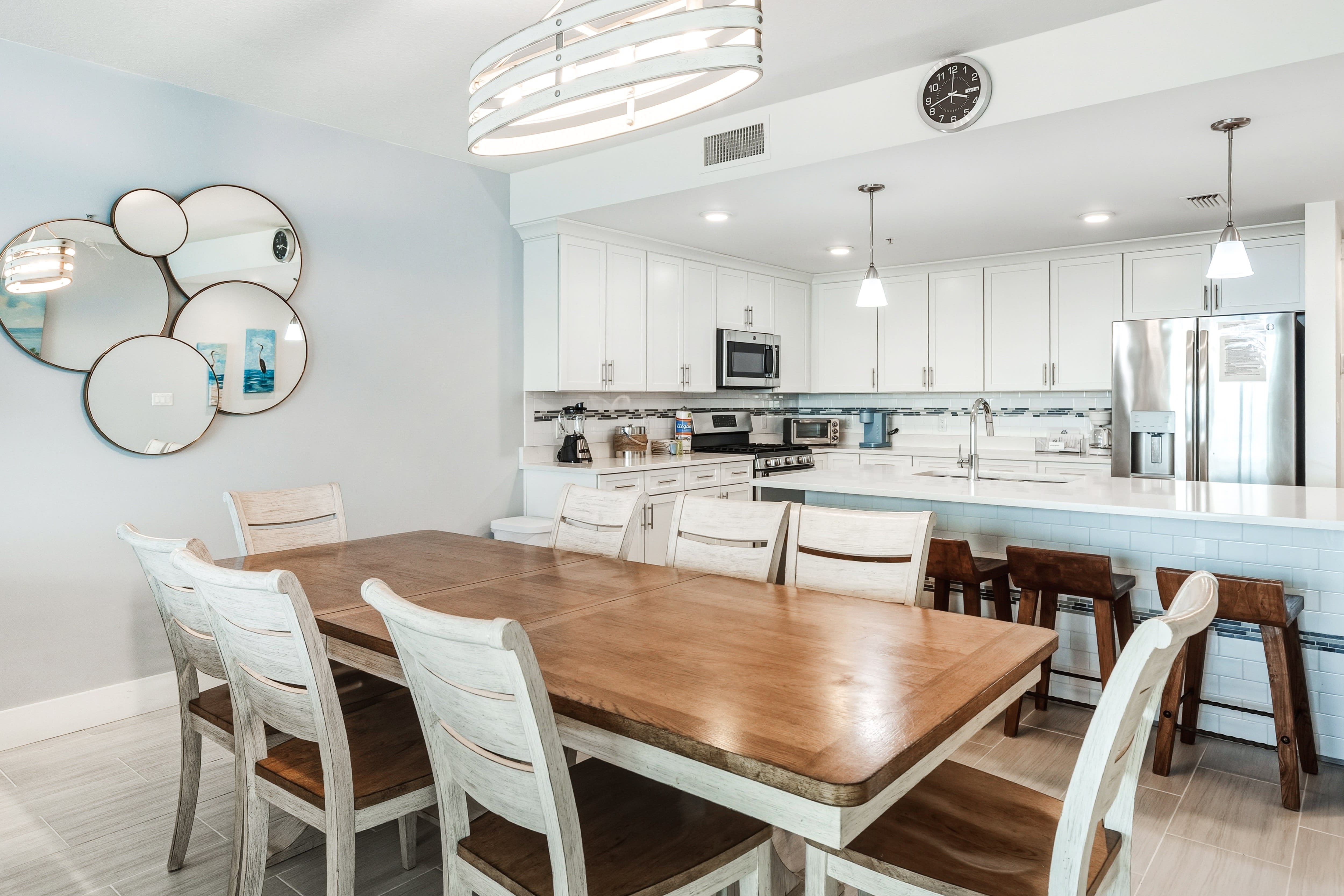 Gather around this inviting dining table where your group can share meals and create memories in this bright, modern space.