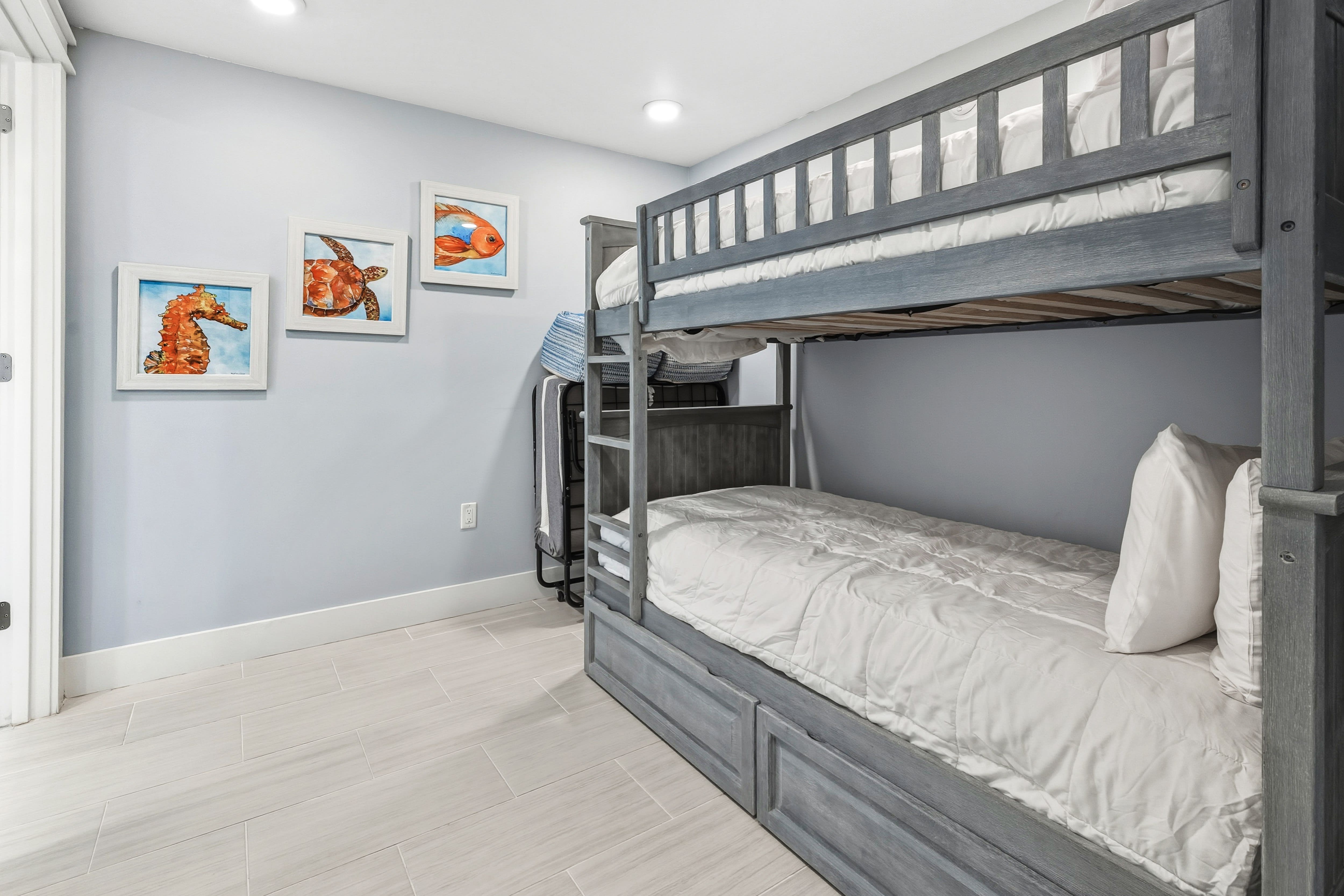Your little ones will love this cozy bunk room with ocean-themed art and comfortable sleeping spaces for family adventures.