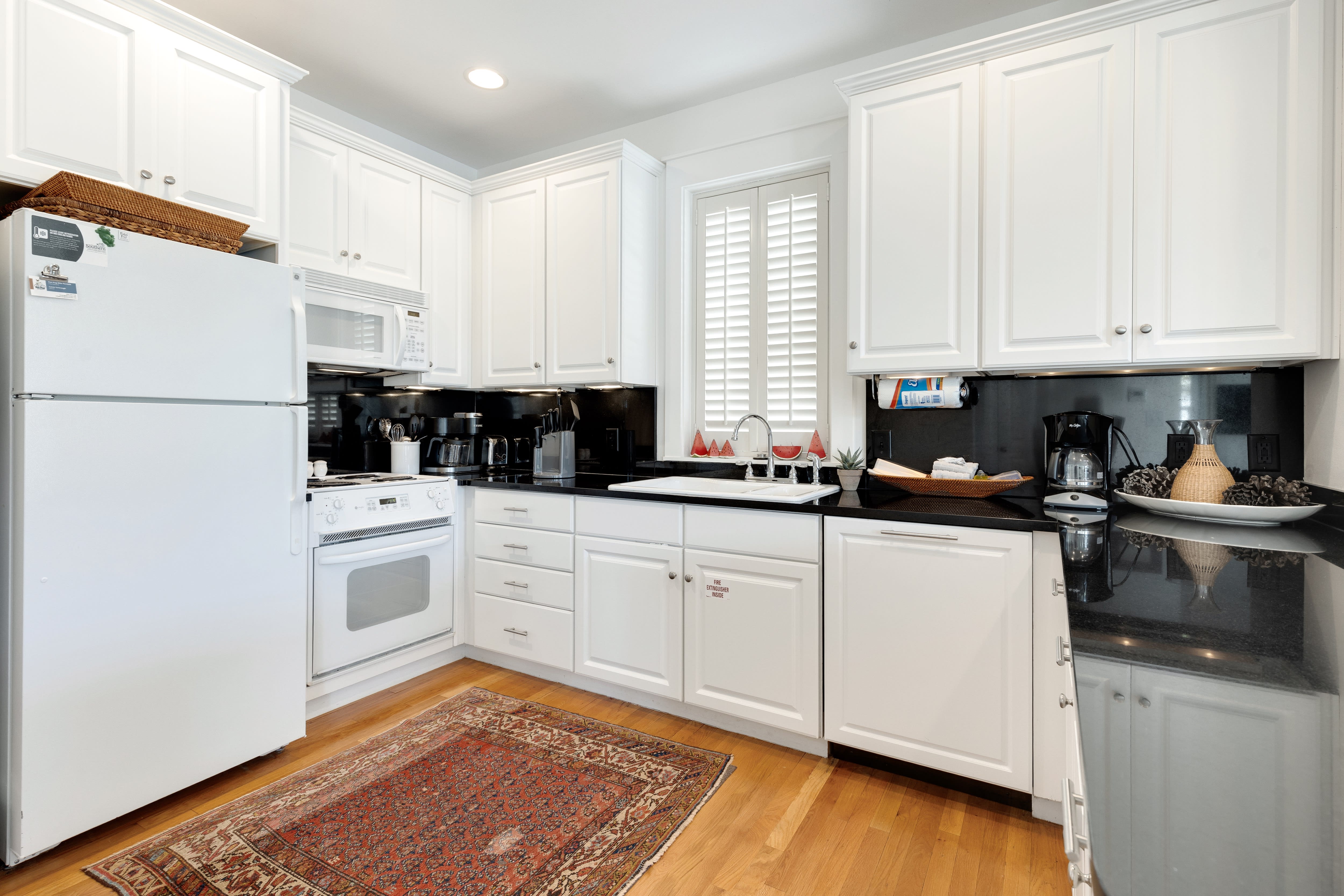 Your fully equipped kitchen features crisp white cabinets, granite countertops, and everything you need to prepare meals during your stay.